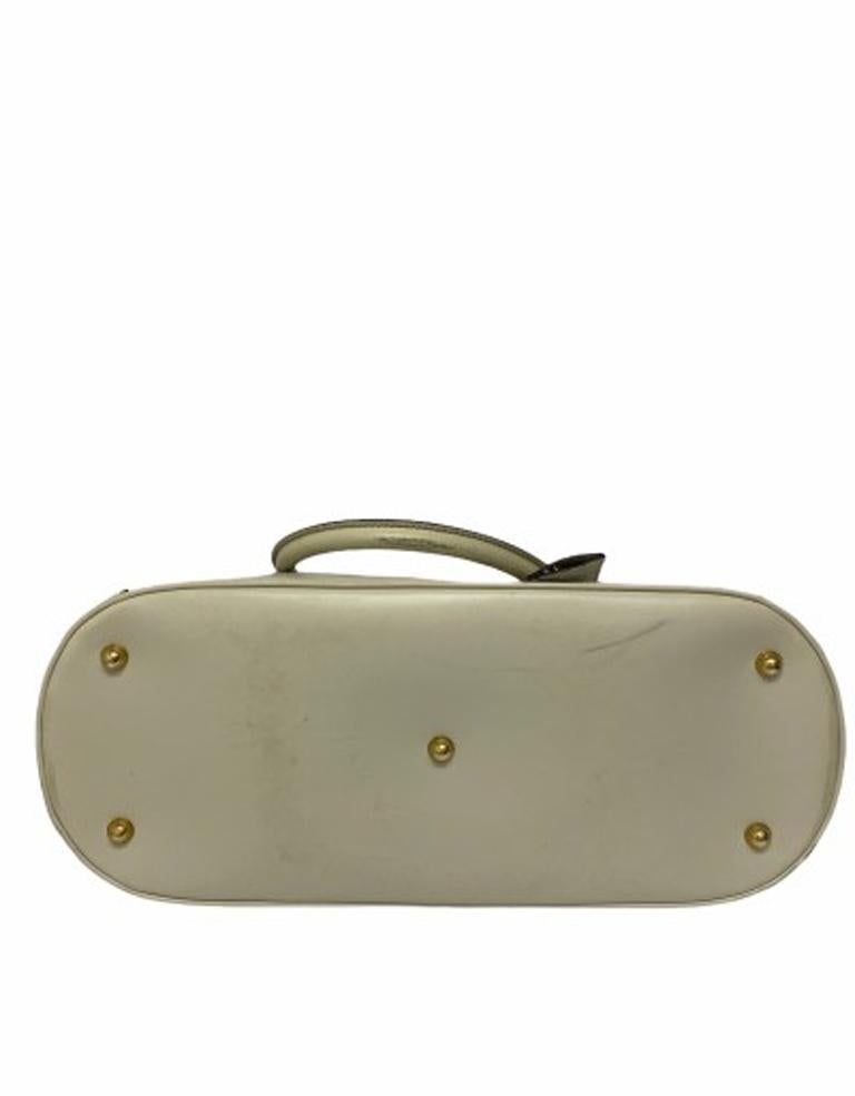 white luggage with leather trim