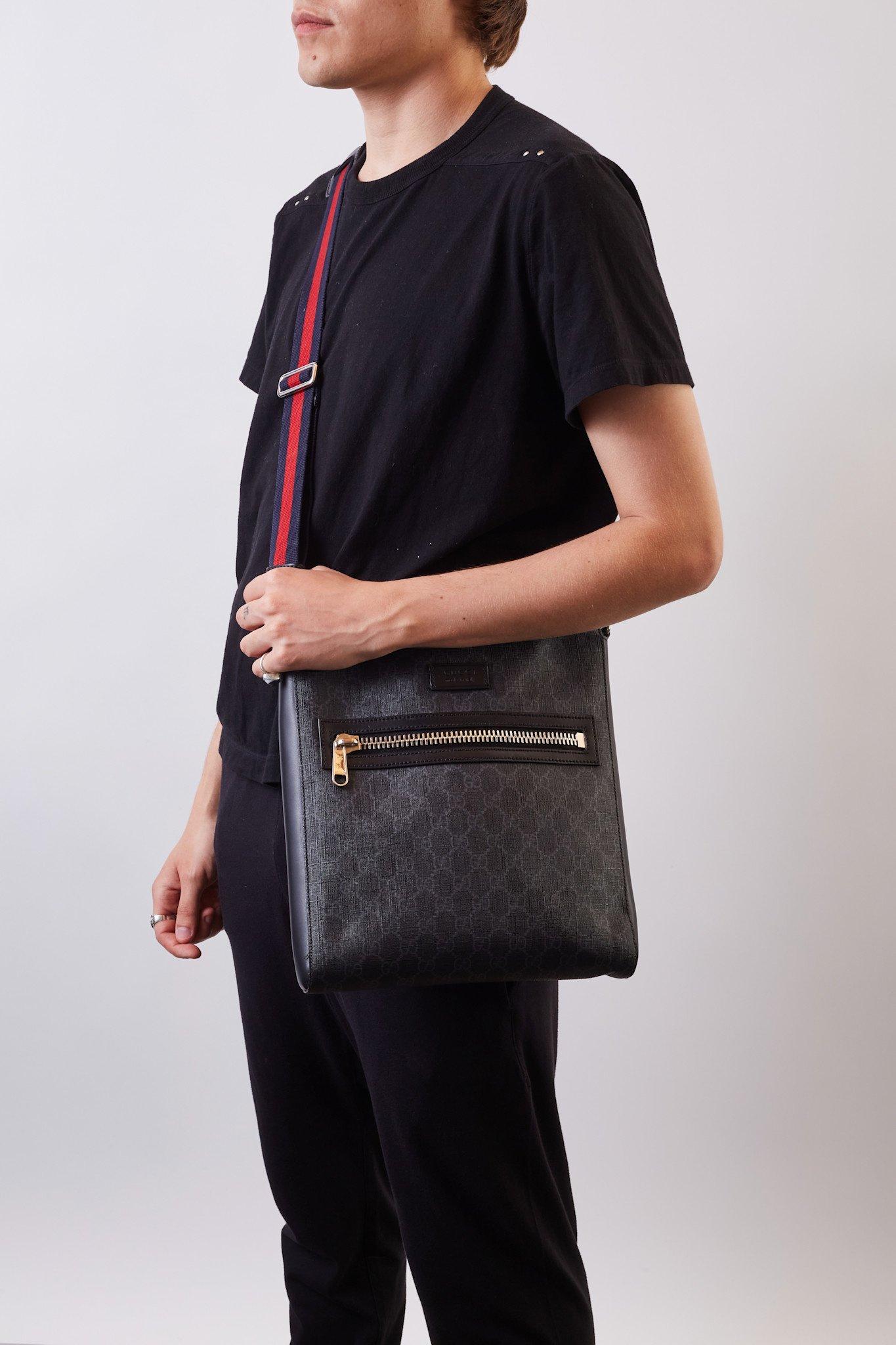 GUCCI GG SUPREME BLACK MONOGRAM WEB FLAT MESSENGER BAG

This messenger bag is made of black Gucci GG Supreme coated canvas with the signature monogram print. It features a web nylon adjustable body strap, silver-tone hardware, a zippered closure,