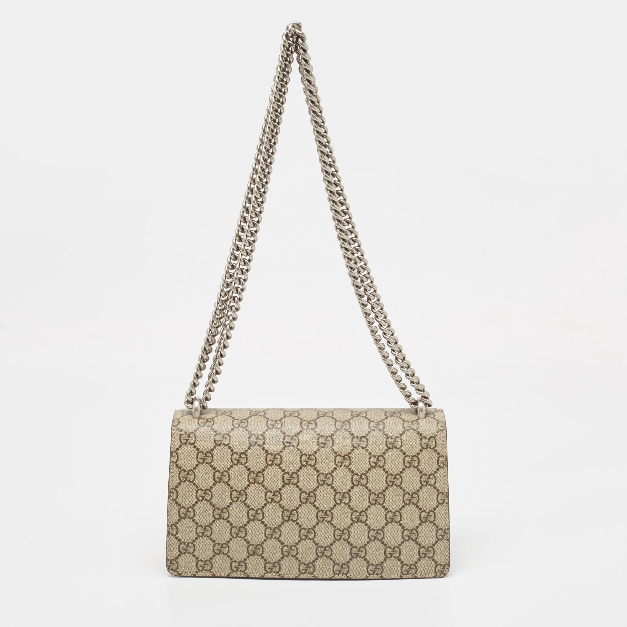 The Gucci GG Dionysus Shoulder Bag exudes elegance with its iconic GG canvas and luxurious suede. Its compact, rectangular silhouette is adorned with the signature Dionysus tiger head closure, making it a sophisticated accessory perfect for any