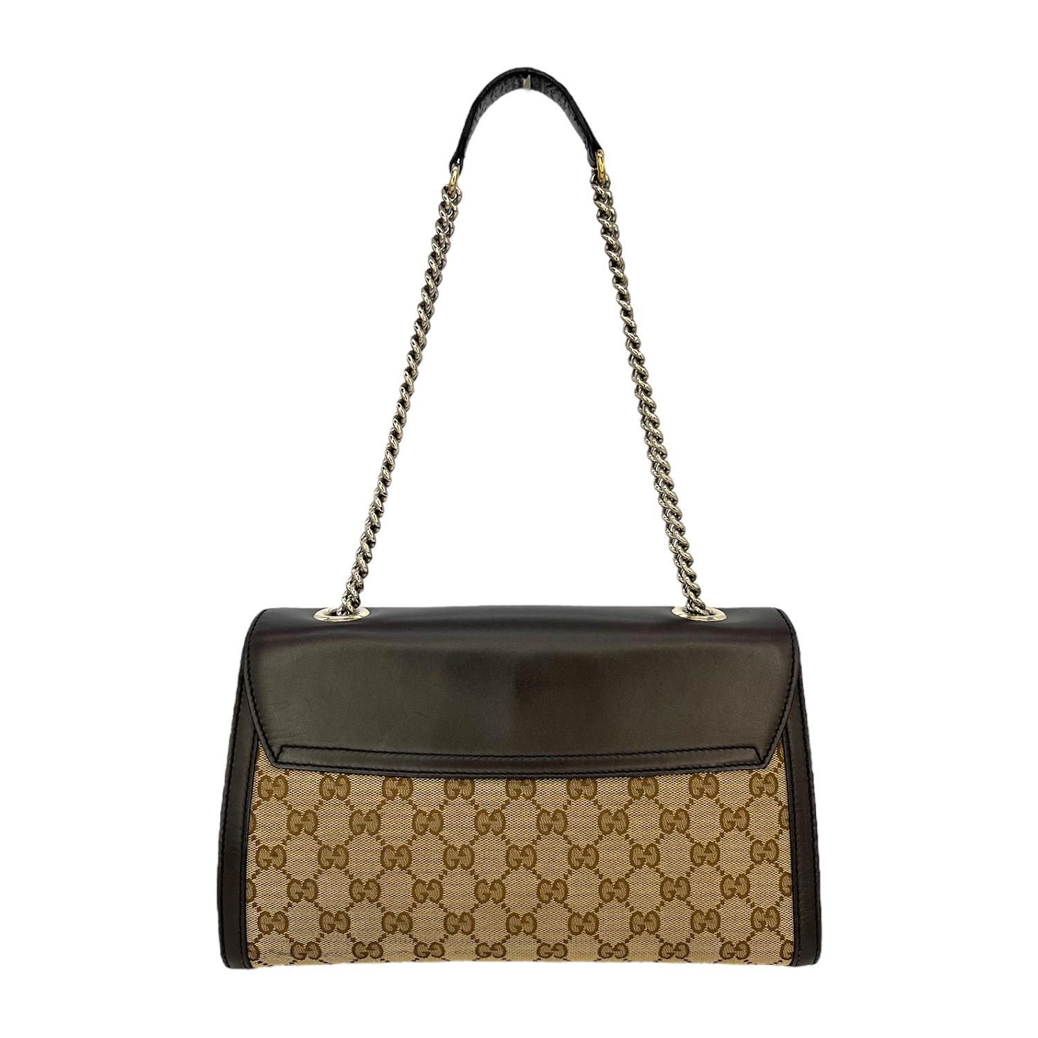 This Gucci GG Supreme Emily Flap Shoulder Bag was made in Italy and it is finely crafted of the classic Gucci GG Supreme canvas exterior with leather trimming and gold-tone hardware features. It has a chain-link and leather shoulder strap. It has a