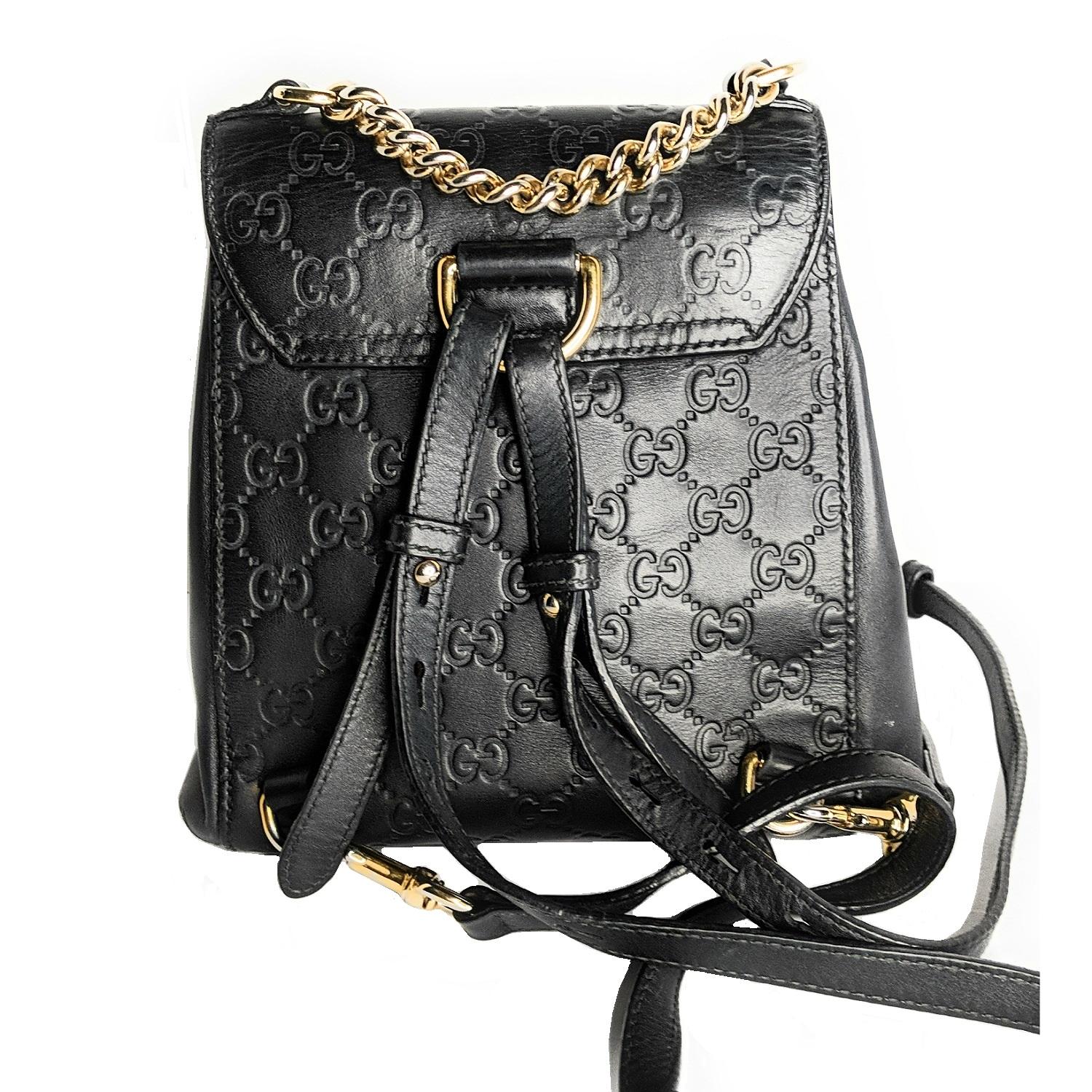Black Signature Gucci Padlock Backpack with gold-tone hardware, single chain-link top handle, dual shoulder straps, peach suede interior, dual slip pockets at interior wall, and S-lock closure at front flap. Includes key and clochette. Retail price