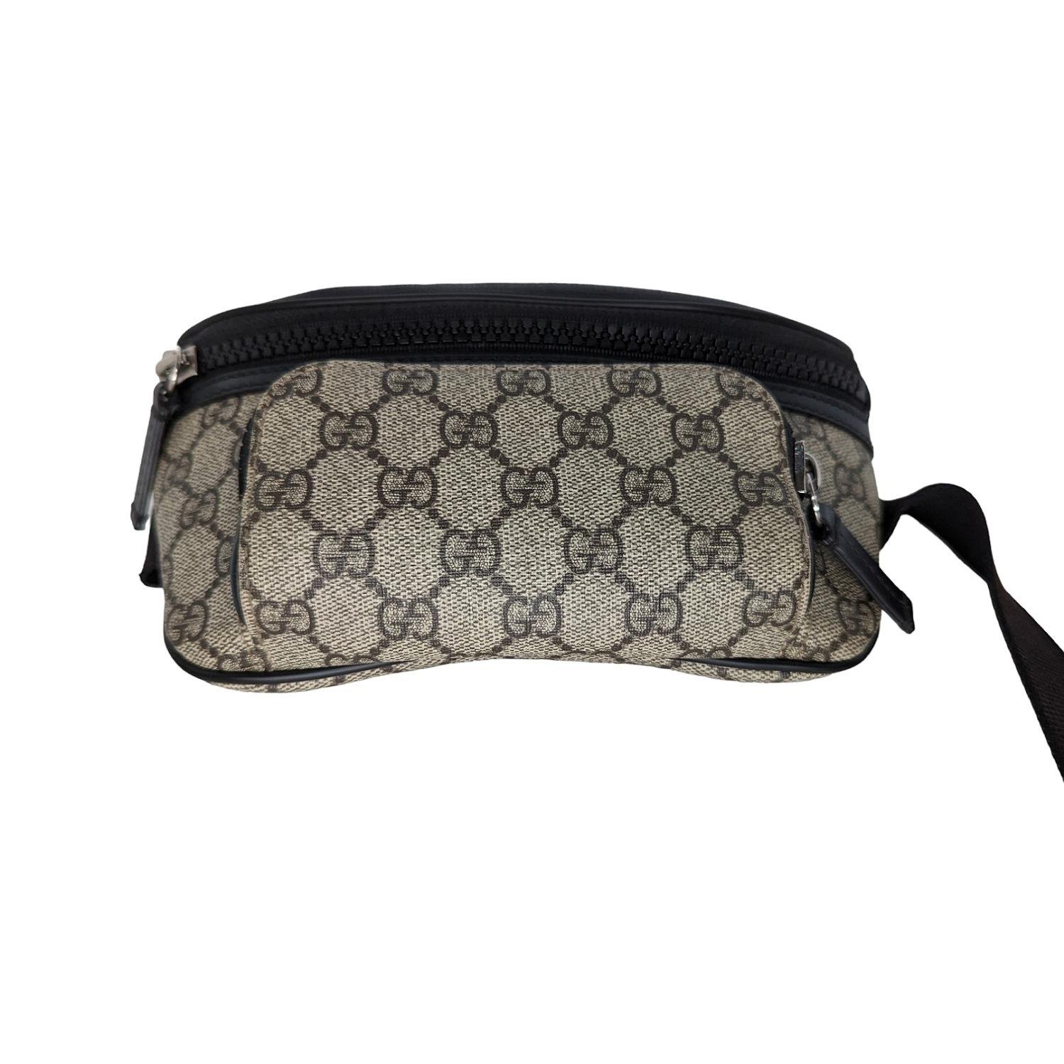 This chic belt bag is finely crafted of coated Gucci GG monogram coated canvas. The bag features a large frontal zipper pocket and a small exterior zipper pocket with an adjustable canvas belt strap with silver-tone hardware. The interior is a dark