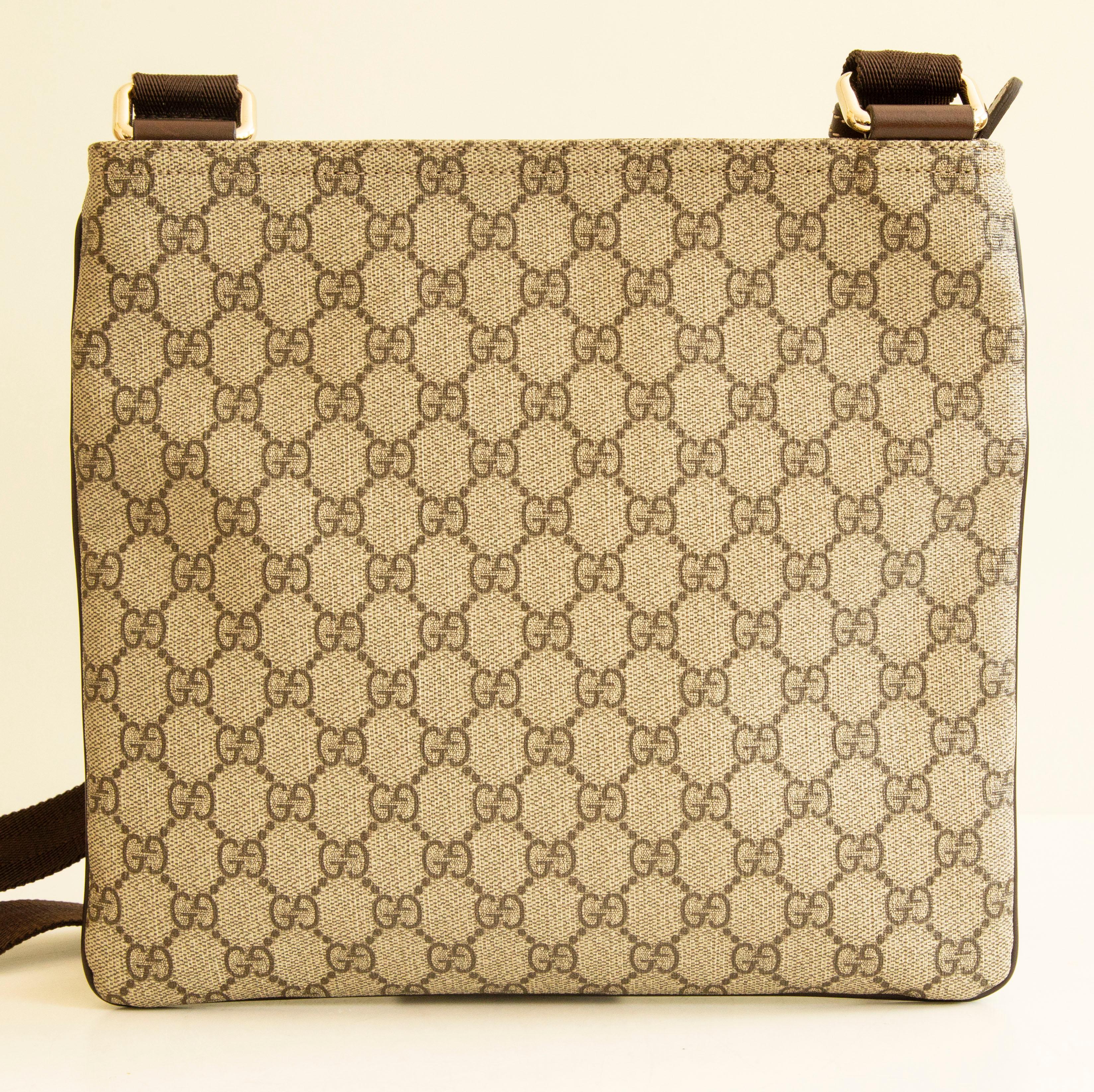 An authentic Gucci messenger bag. The bag features a gg supreme exterior, brown leather trim, and silver-toned hardware. The interior is lined with beige fabric and consists of the main compartment and the front zipped pocket, there is one slip
