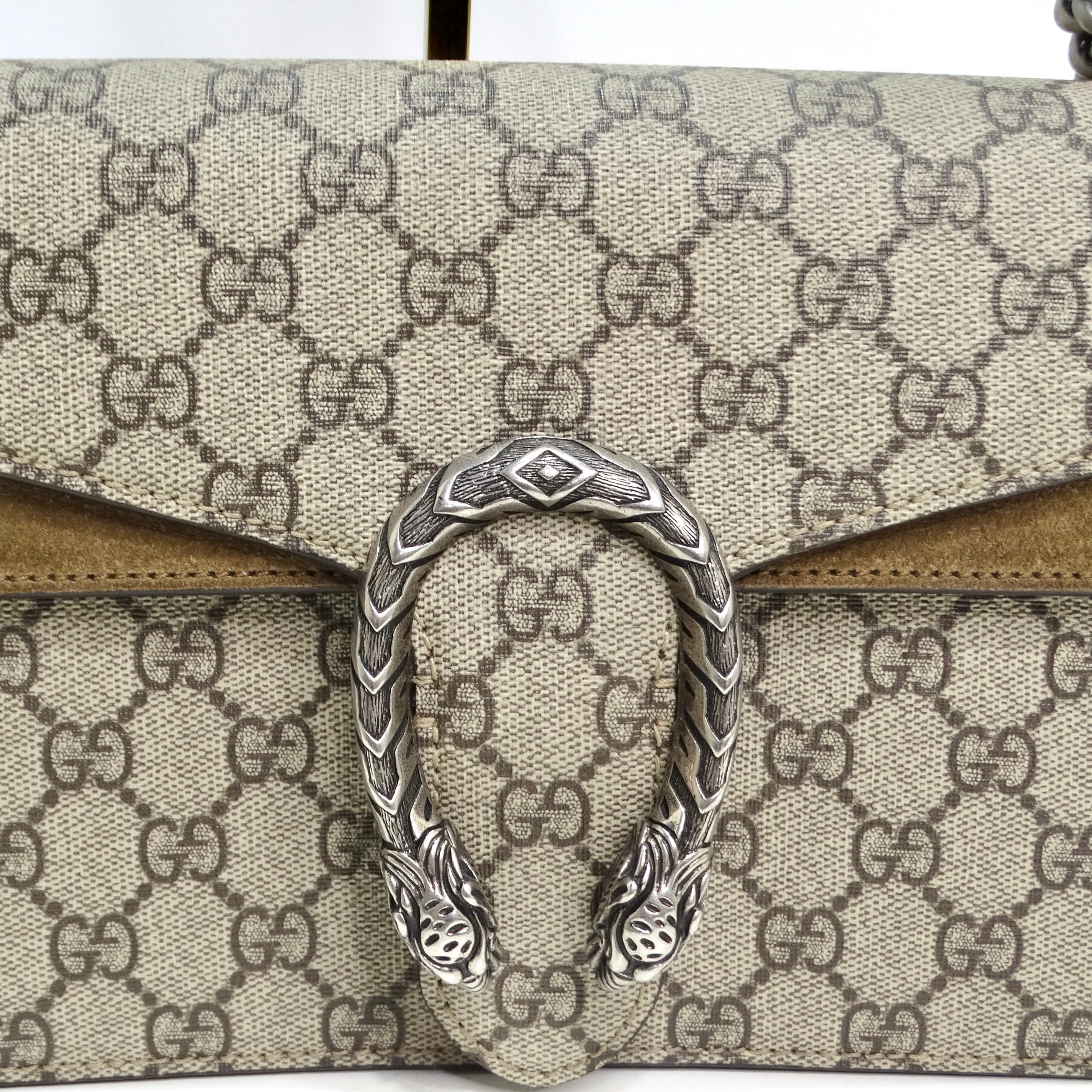 The Gucci GG Supreme Monogram Suede Dionysus Shoulder Bag is a chic and modern accessory that seamlessly combines timeless elegance with versatile design. Crafted from taupe Gucci GG monogram canvas, the bag exudes sophistication and showcases the