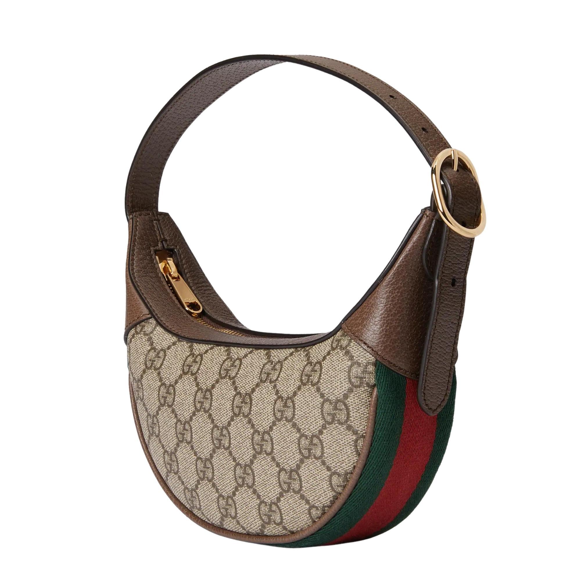 This crescent/croissant shaped mini bag is constructed from the House's monogram canvas. The half-moon silhouette is infused with a retro spirit, recalling '90s designs. The bag features beige and ebony GG Supreme canvas, brown leather trim, a green
