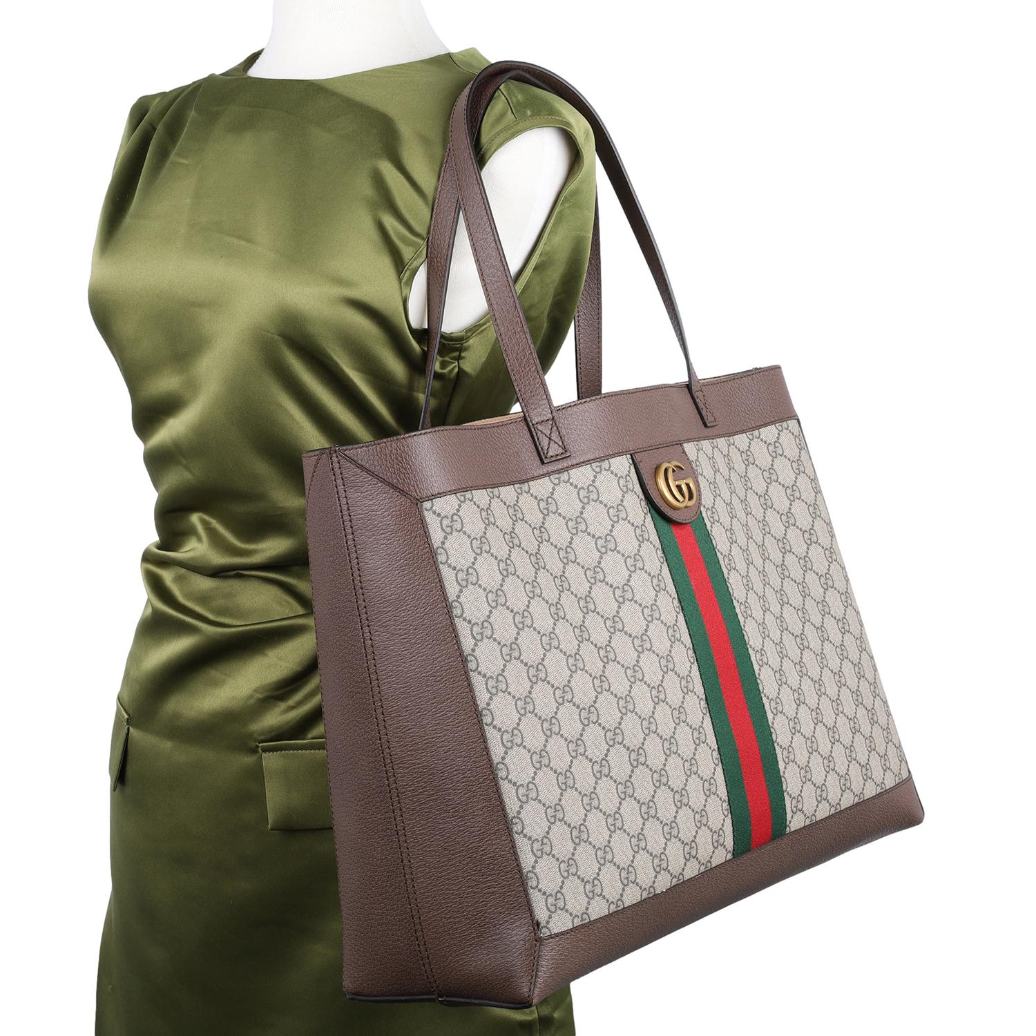 Authentic Gucci GG Supreme Monogram Web Ophidia tote bag. Gucci brings to you this amazing bag that is smart, versatile, and modern. This tote features GG-printed canvas with leather trim, dual leather handles, green and red web, and aged gold