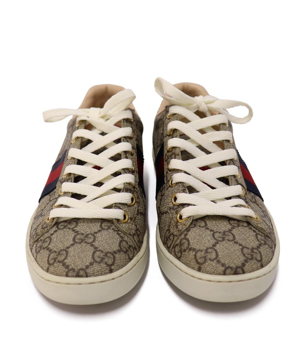 Gucci GG Supreme Monogram Women's Ace Low-Top Sneaker, features  a round toe, lace-up fastening, signature wed detail and red leather detail on the heel of one shoe and blue on the other. 

Exterior Material: Coated Canvas
Lining Material: