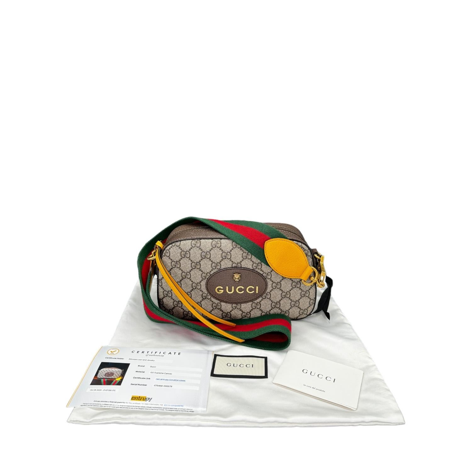 This stylish messenger bag is crafted of classic brown on beige Gucci GG monogram coated canvas, with dark brown leather trim, and an oval Gucci tag with a brass tiger head on the front. The bag features a green and red web stripe canvas shoulder