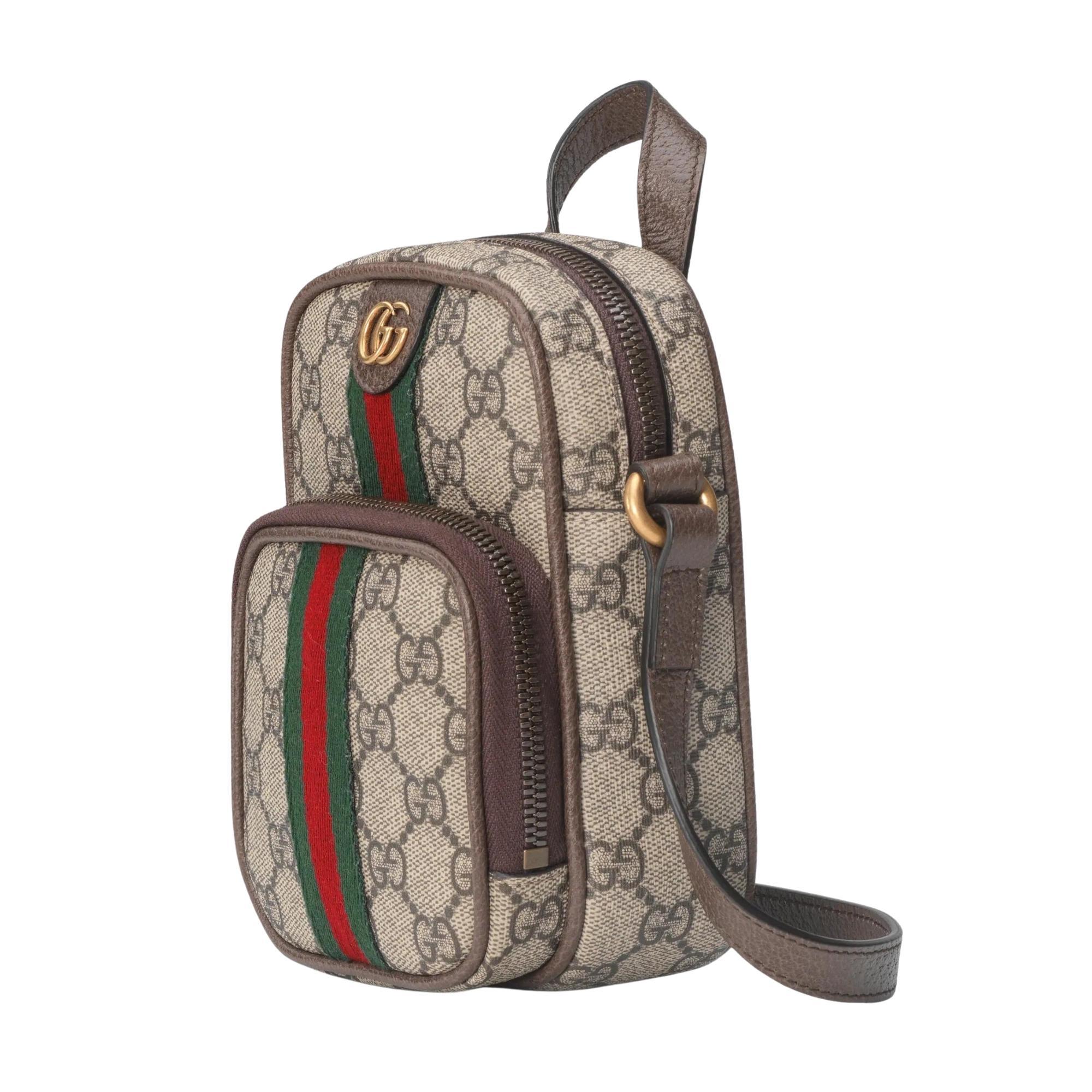 This bag is made with GG Supreme canvas in beige and ebony with brown leather trim. The bag features the classic green and red web at front, GG hardware, antique gold-toned hardware, a flat leather top handle, a shoulder strap and a front