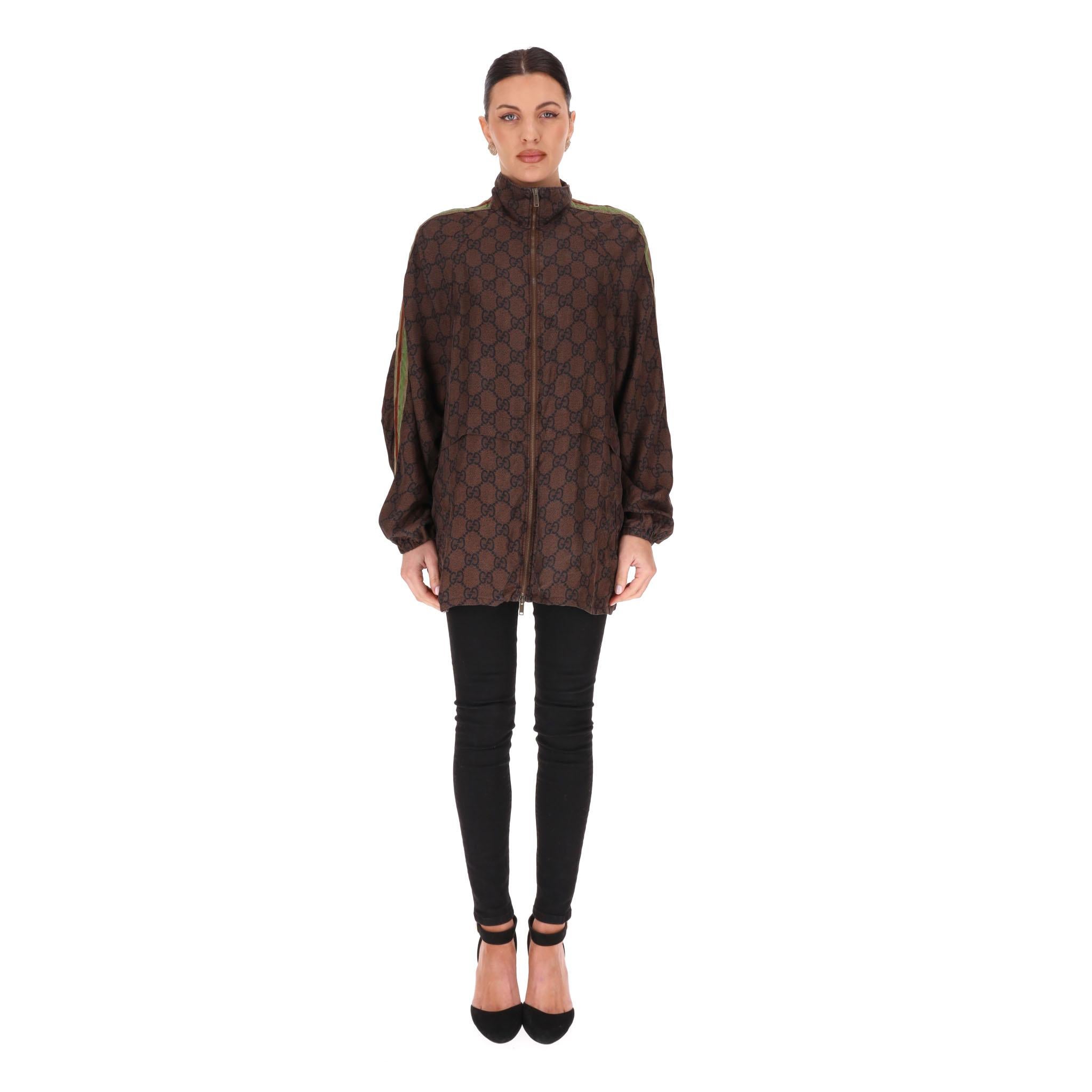 Gucci GG Supreme Web Stripe Silk-Twill Jacket

Brown signature GG Supreme print jacket crafted from silk with contrast Web stripe metallic gold, red and green detail along the sleeves.

 Featuring centre zip closure, high neck and front