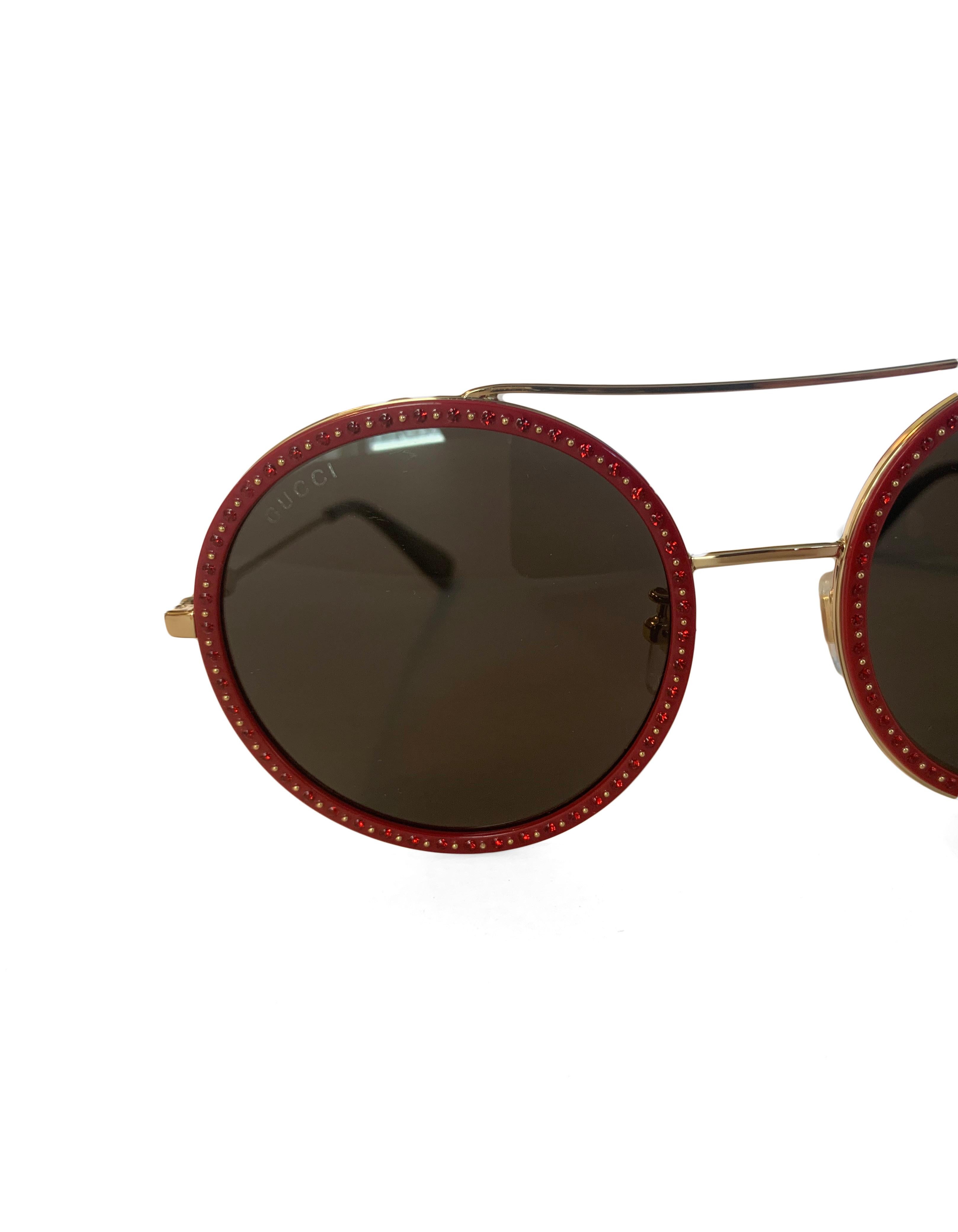 Gucci GG0061S Red Round Frame Sunglasses. Features red crystal and goldtone metal studded detailing. Features small gold GG logo and bee detail at arm

Made In: Japan
Color:Red and gold
Hardware: Goldtone
Materials: Acetate, crystal, metal
Overall