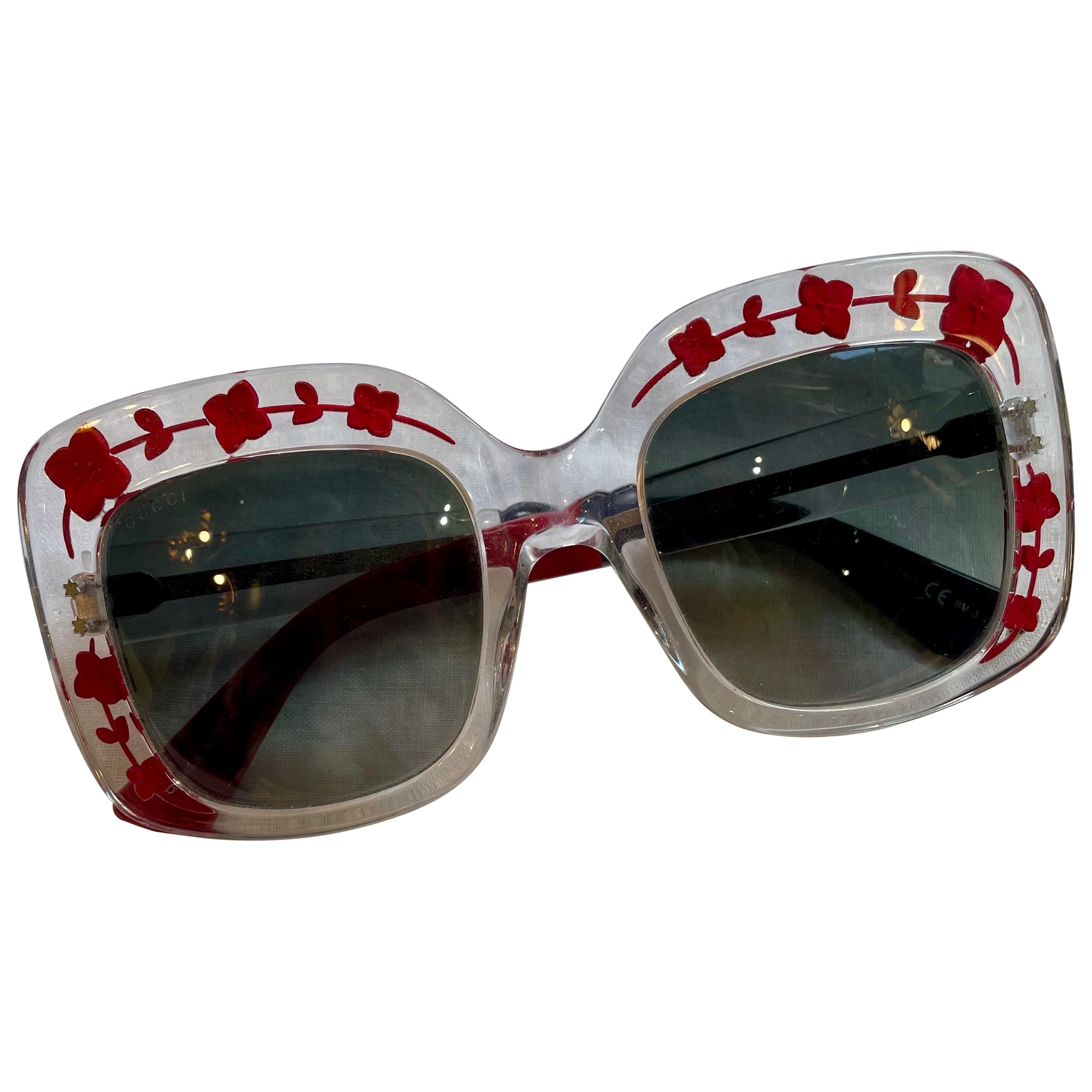 Gucci glasses in transparent plastic with red flowers