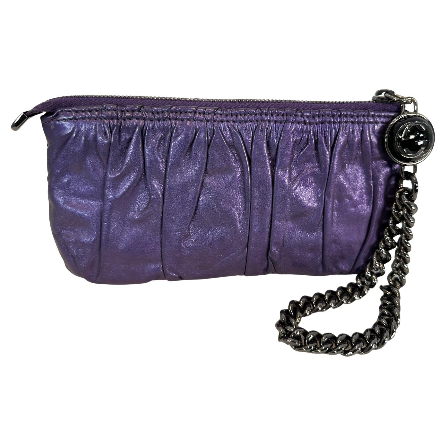 Gucci Glaxy Purple Leather Wristlet with Gunmetal Chain Strap 
Gucci Logo Charm
