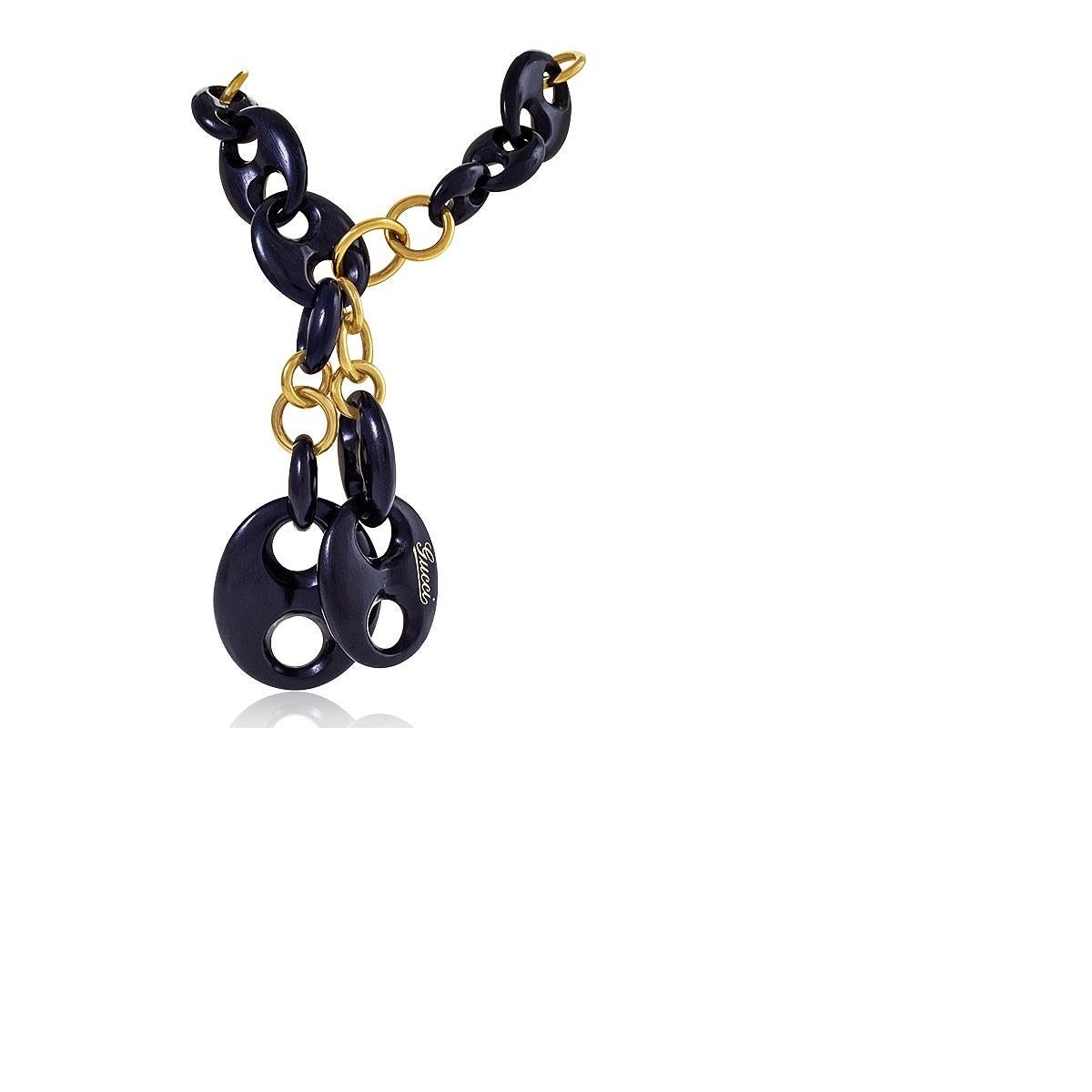 An Italian Late-20th Century 18 karat gold necklace with stylized ebony links by Gucci. The large-scale necklace features variously-proportioned ebony links connected with polished gold link sections. The pattern completes a circle around the neck