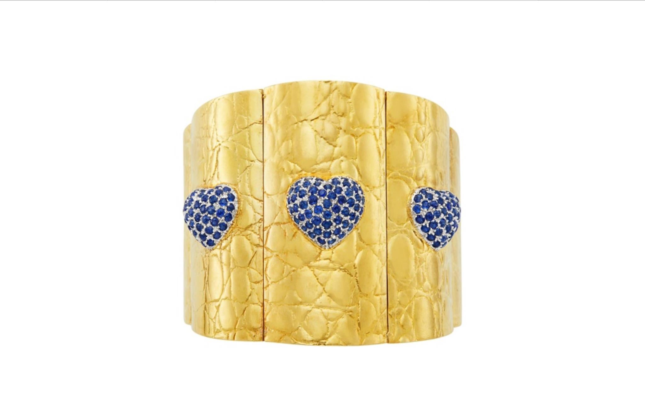 1970s Gucci cuff bracelet in 18kt yellow gold featuring sapphire hearts. Matching earrings available.
Bracelet measures 6.75 in. (17.1 cm.)