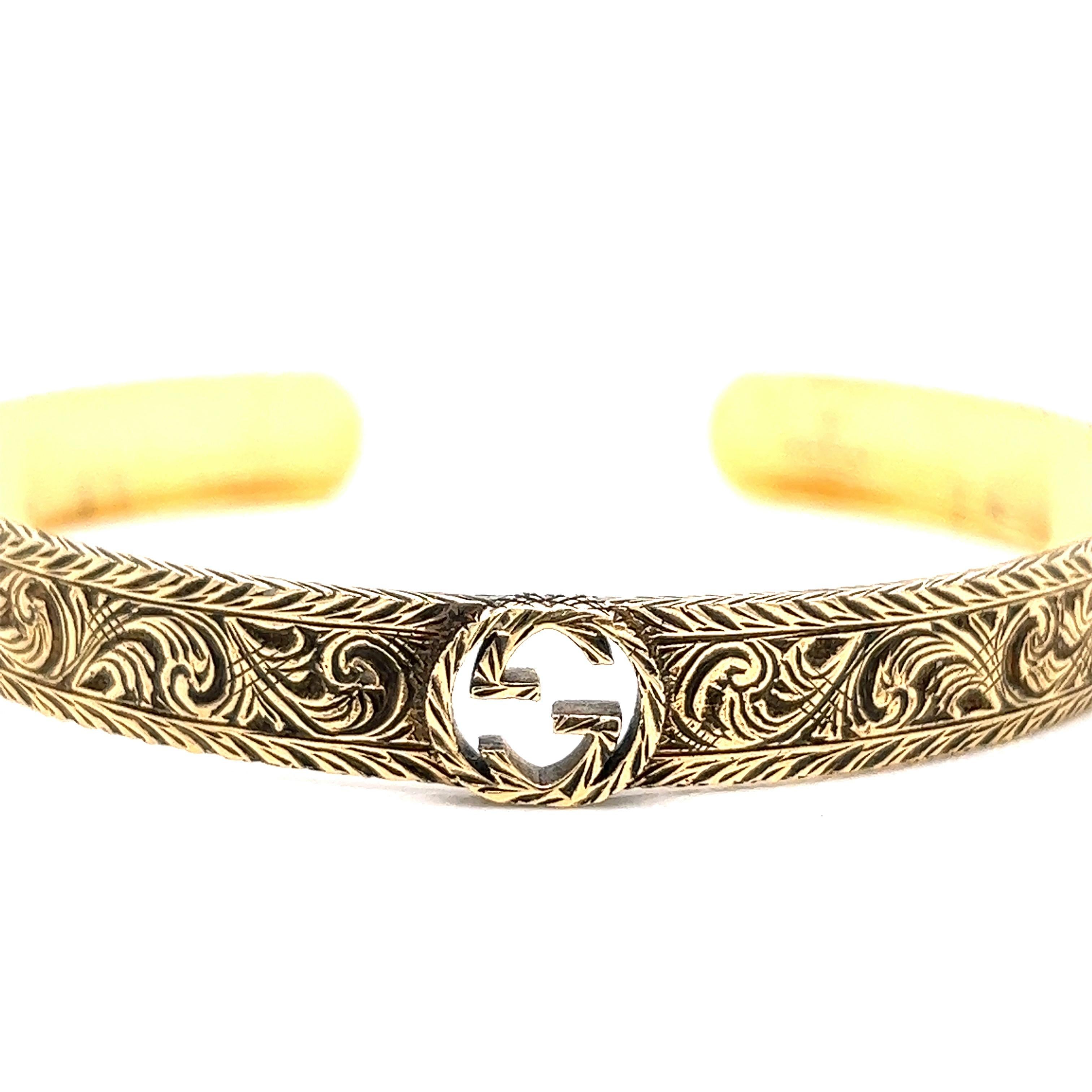 Gucci 18 karat yellow gold bangle bracelet

Intricate swirl designs on the outer band; marked Gucci, made in Italy, 18, Au750

Inner circumference: 6.63 inches; Band width: 0.8 mm
Total weight: 20.4 grams