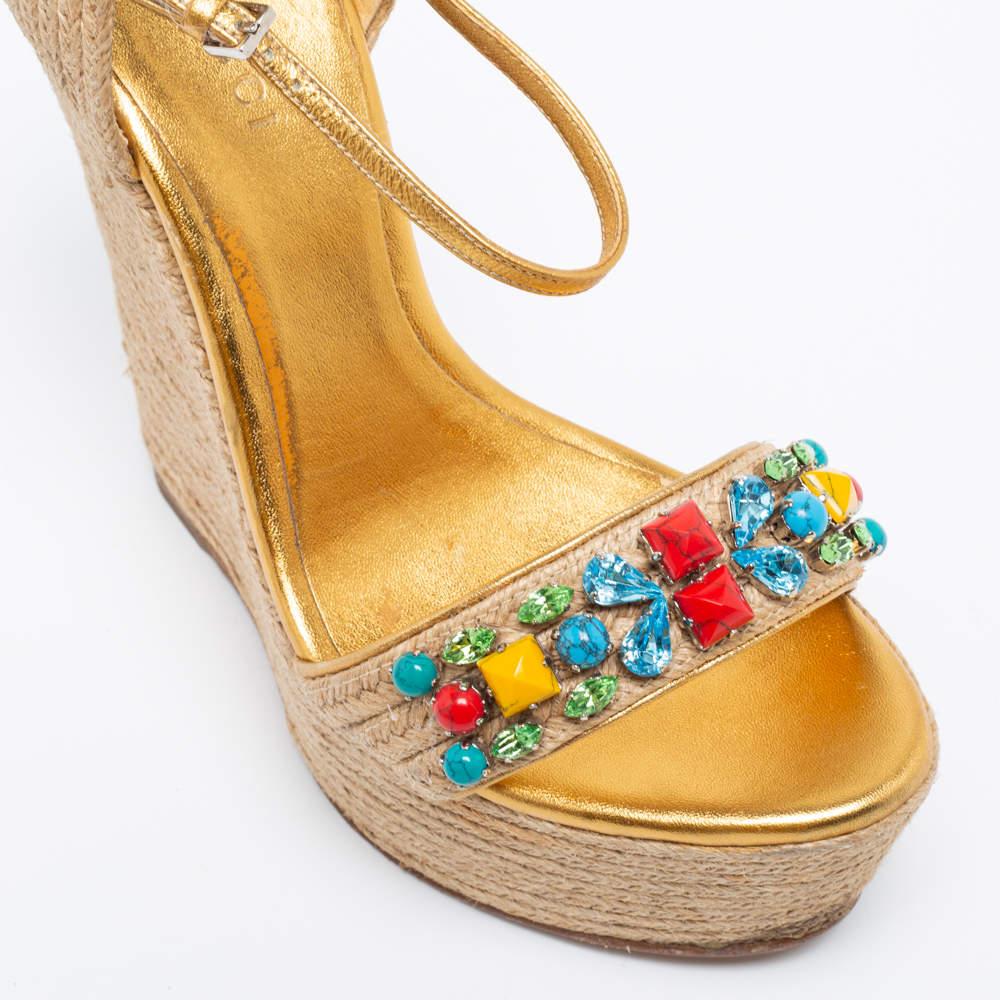 These wedges by Gucci are to complement summer soirées. They are made from jute as well as gold leather and added with open toes, embellished uppers, ankle strap closure, and wedge heels.

