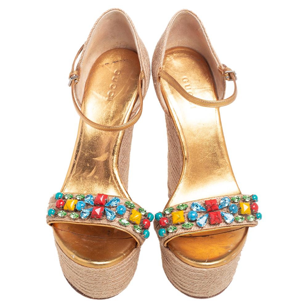 Stay stylish with these beautiful jute and leather trim sandals. Let these gorgeous sandals with multicolored crystal embellishments speak for themselves in terms of fashion. These sandals from Gucci are designed with high wedges and buckled straps