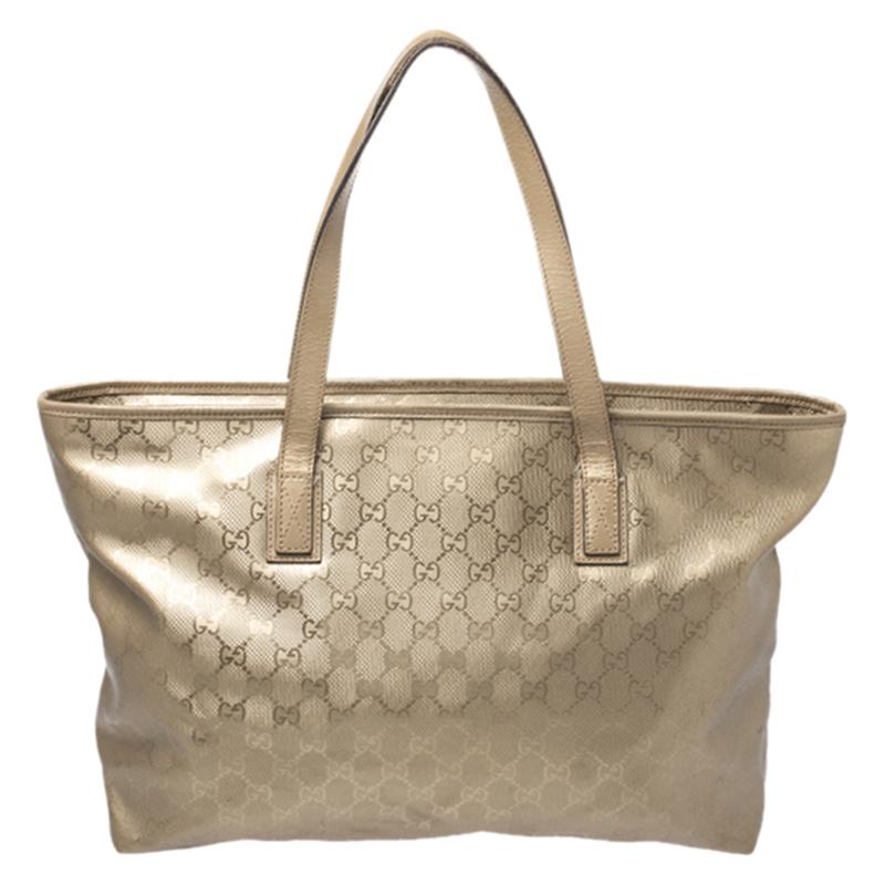 This chic and feminine shopper tote is from Gucci. The bag is made from GG Imprime canvas and is styled with leather trims. It features a zip closure that opens to a fabric-lined interior that can fit your daily essentials. Flaunt this beauty
