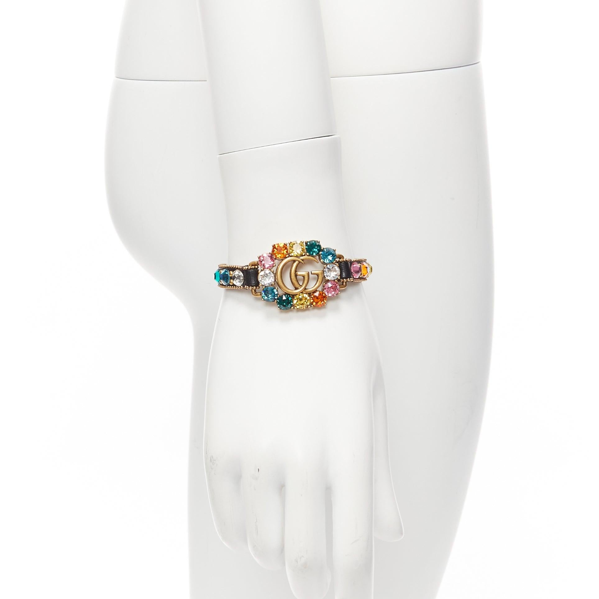 GUCCI gold GG log rainbow crystal embellished black leather bracelet
Reference: TGAS/D00986
Brand: Gucci
Designer: Alessandro Michele
Material: Leather
Color: Black, Multicolour
Pattern: Crystals
Closure: Buckle
Made in: Italy

CONDITION:
Condition: