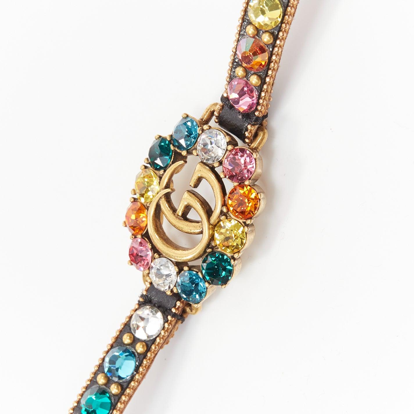 Women's GUCCI gold GG log rainbow crystal embellished black leather bracelet For Sale