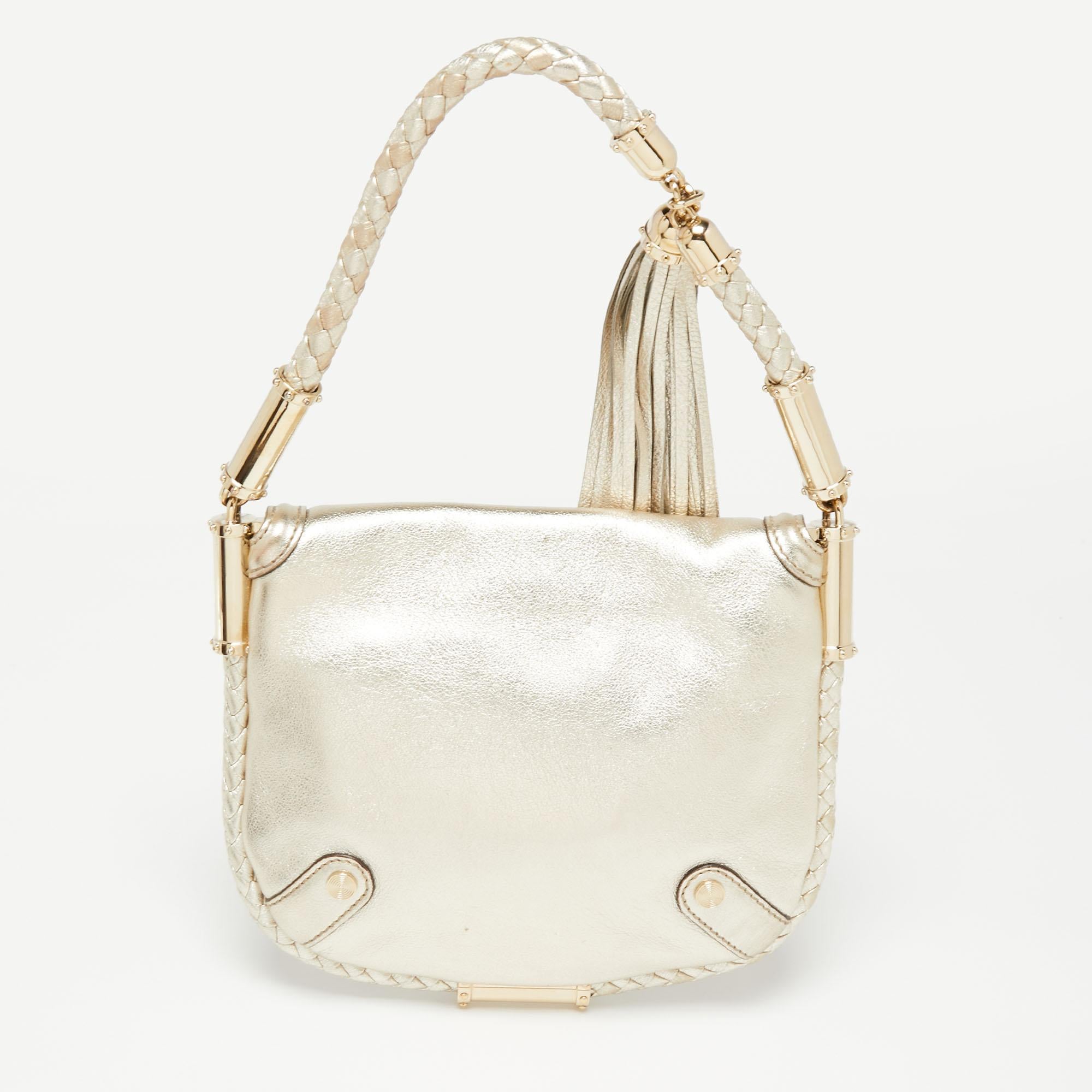 Simple details, high quality, and everyday convenience mark this Britt hobo by Gucci. The bag is made of gold glossy leather and it features a single handle, a gold-tone GG logo on the front, and a spacious interior.

Includes: Original Dustbag