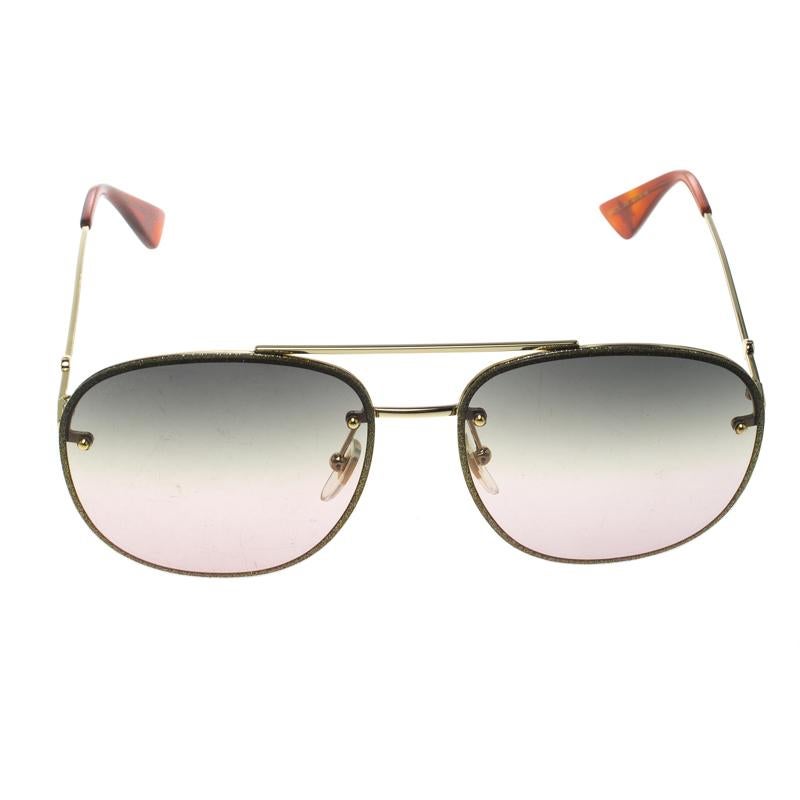 Styled to eloquently express your personal style, these Gucci sunglasses come in a gold metal and green frame with the GG logo detailed on the temples. While its design will make you stand out, the gradient lenses will provide sufficient