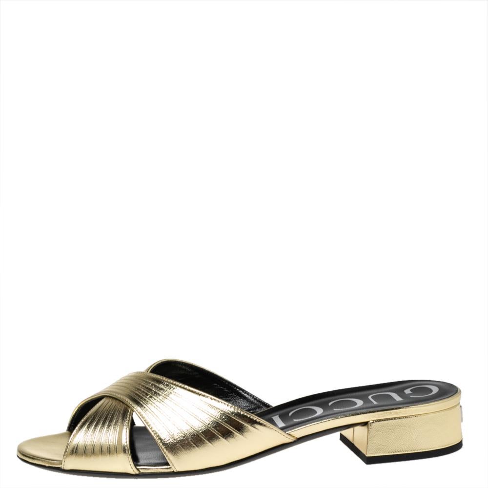 These slide sandals from the House of Gucci are a pair that you will be proud to own! Made from gold leather, these sandals flaunt a crisscross strap on the upper and an easy slip-on style. They are elevated on 2.5 cm heels. Enhance your attire with
