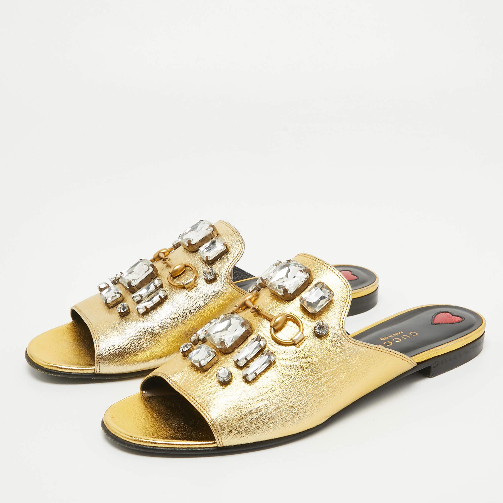 Frame your feet with these Gucci gold flat slides. Created using the best materials, the flats are perfect with short, midi, and maxi hemlines.

