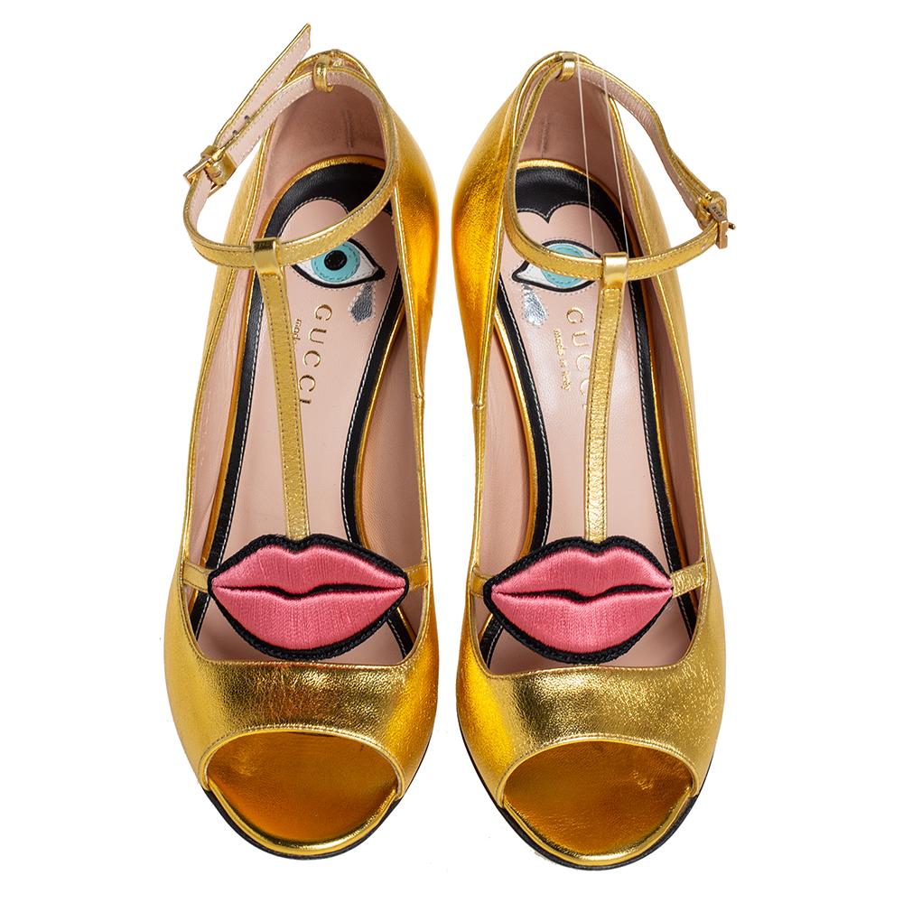How can one not fall in love with these pumps by Gucci! They've been beautifully crafted from gold leather and styled with embroidered lips on the straps. The pumps carry peep toes, ankle fastenings, and 10 cm heels.

Includes: Original Dustbag
