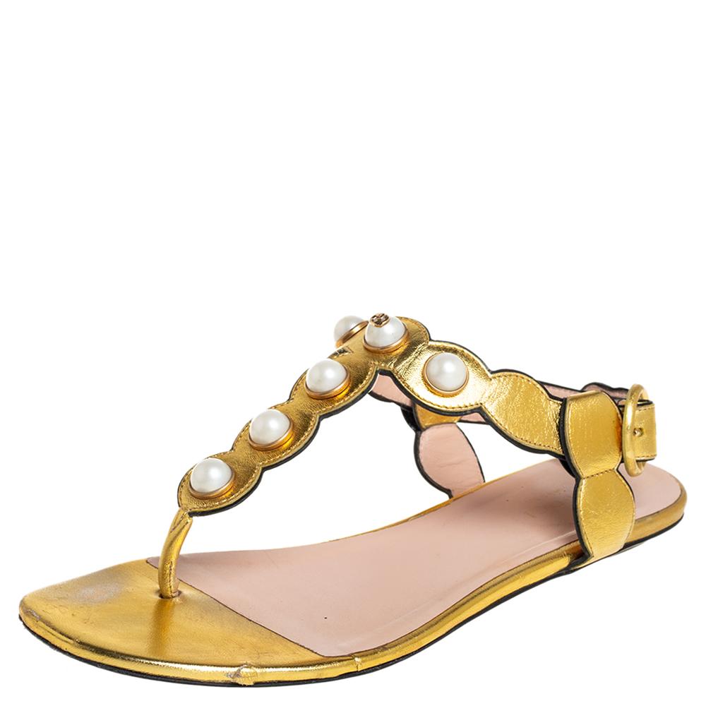 Perfect for channeling an air of elegance, these sandals from Gucci are worth investing in. The gold sandals are crafted from leather and feature a T-strap design with pearls, buckled ankle straps, comfortable leather-lined insoles, and gold-tone