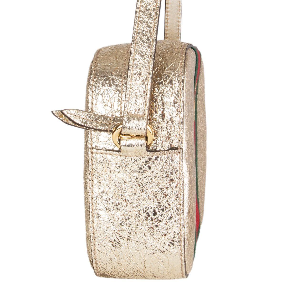 Gucci 'Webby Bee' crossbody bag in textured light gold-tone calfskin with signature Web stripes featuring  an embroidered gold bee. Comes with an adjustable crossbody strap. Interior is lined inoff-white  linen and has two open pockets. Has been