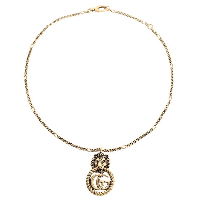 Authentic New Gucci Lion Head Double G Pendant Necklace.

Features Aged gold-finish metal necklace with lion head pendant and double G logo, Lobster clasp closure.

Chain Length: 19