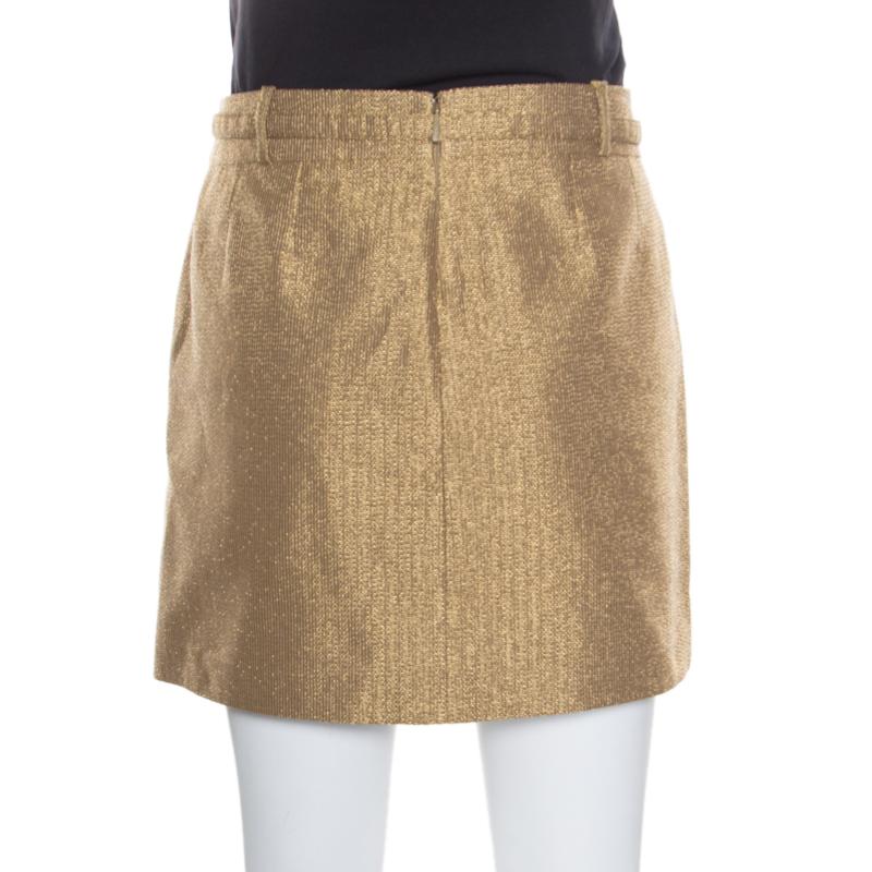 Who says only dresses can make you look chic and stylish when you have this fabulous mini skirt from Gucci that spells elegance. This gold skirt is made of a cotton blend and features a flattering silhouette. It flaunts a buckled belt at the waist