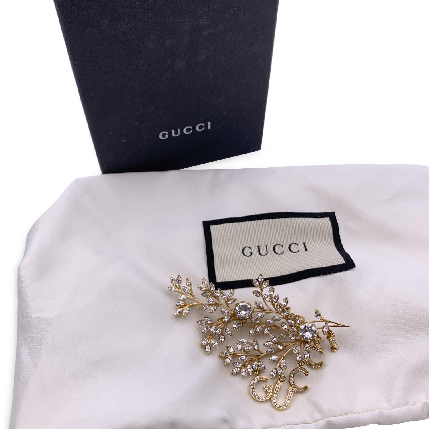 Beautiful GUCCI single gold metal earring / ear cuff with crystals. Dangling Gucci script. Double clip on the back. Total length: 3.5 inches - 8.9 cm. Retail price is 850 euros Condition A+ - MINT Gucci box and pouch included. Please, look carefully