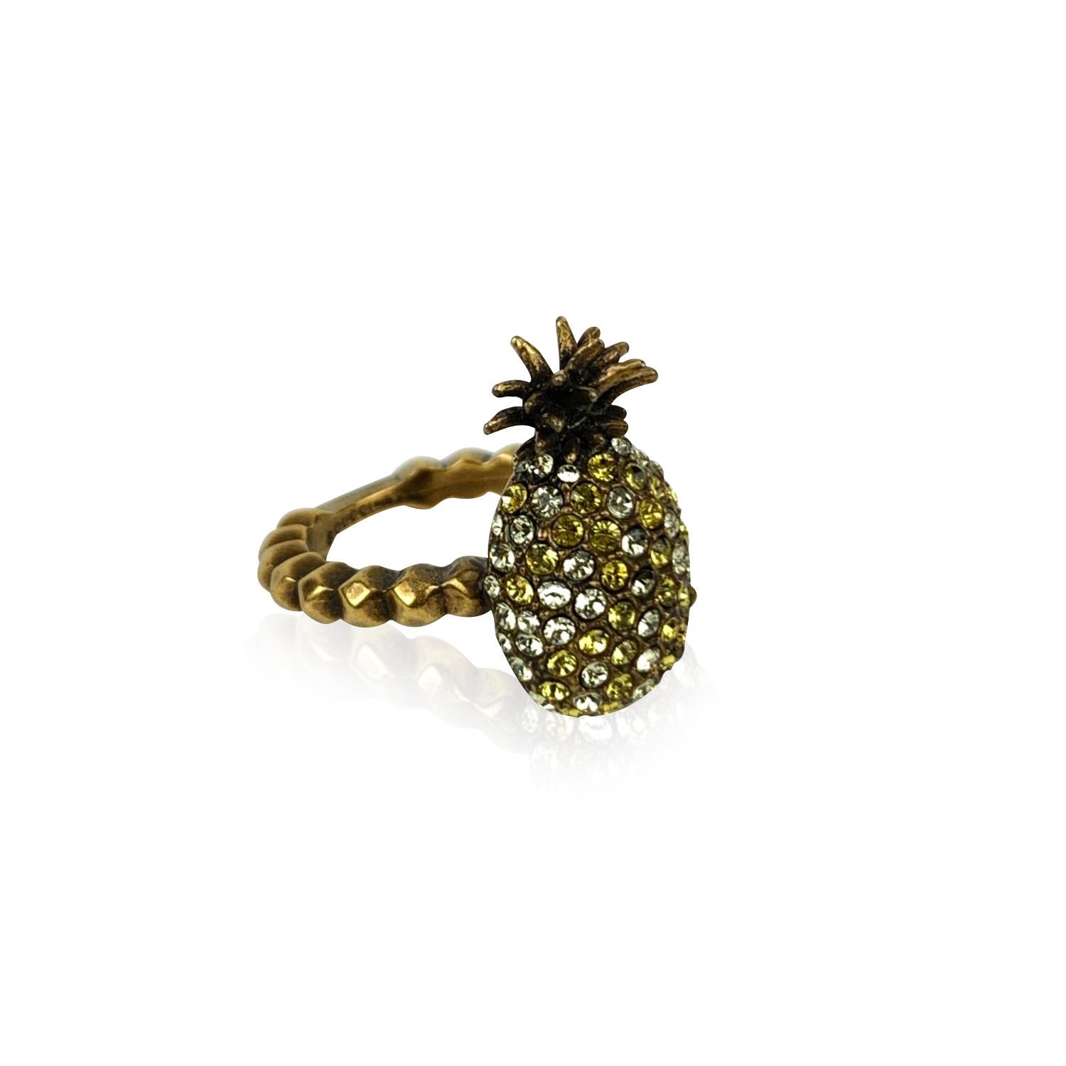 Beautiful embellished 'Pineapple' ring by Gucci. It features an aged gold metal body, with a studded design. The pineapple ornament on top is embellished with white and yellow crystals. Size: M (it should correspond to a size 7.75 US, 56 EU, 16 IT).