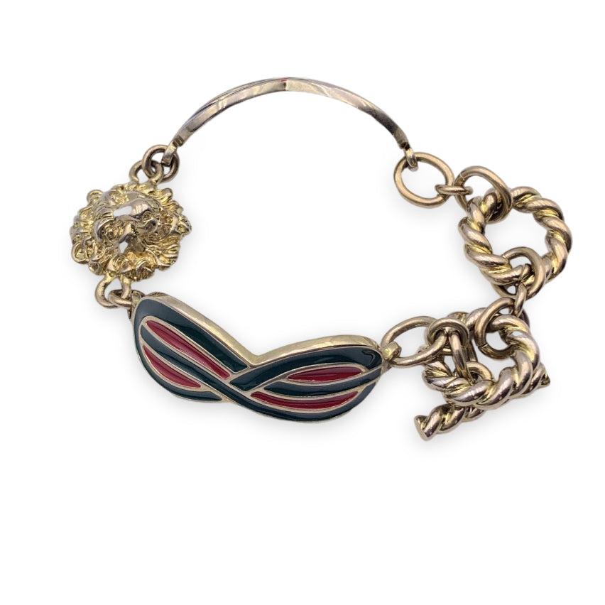 Beautiful bracelet by Gucci, made of shiny gold-colored brass with lion head and red/green web enamelled detail. Toggle closure. Total lenght: 7 inches - 17.8 cm. 'Gucci - Made in Italy' engraved internally. Condition A - EXCELLENT Gently used.