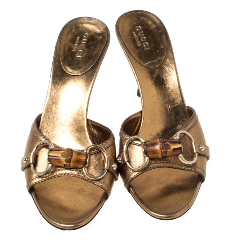 These Gucci slides are gorgeous from every angle. Made from metallic gold leather, they feature open toes, gold-tone Horsebit detailing with bamboo accents, leather lining, and 8 cm heels to lift you.

Includes: The Luxury Closet Packaging


