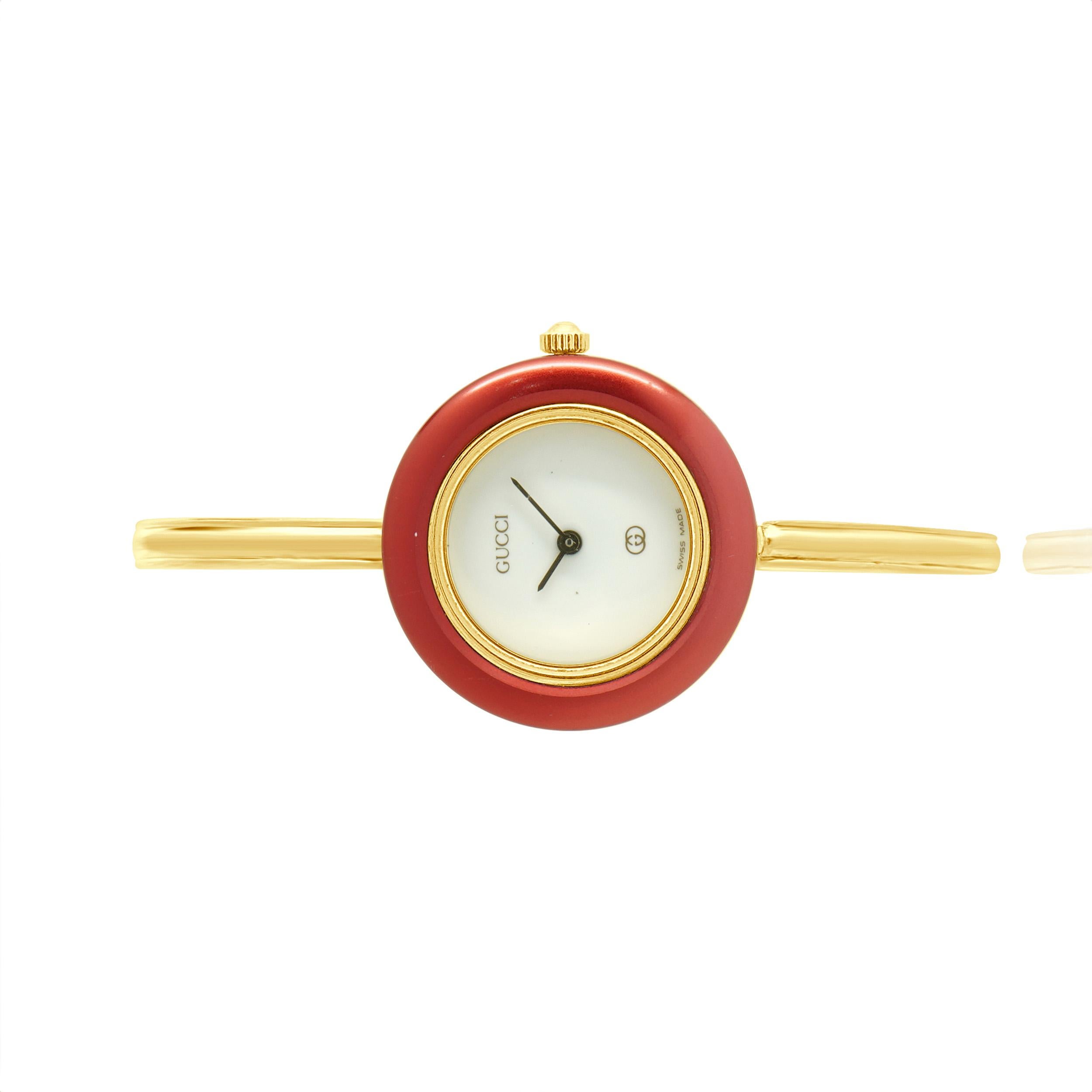 Movement: quartz 
Function: hours, minutes
Case: round 25mm gold plated case with 10 interchangeable bezels, plastic crystal, pull/push crown
Band: gold tone bangle bracelet with jewelry clasp, bracelet fit for 6 ½ inch wrist
Dial: white dial with