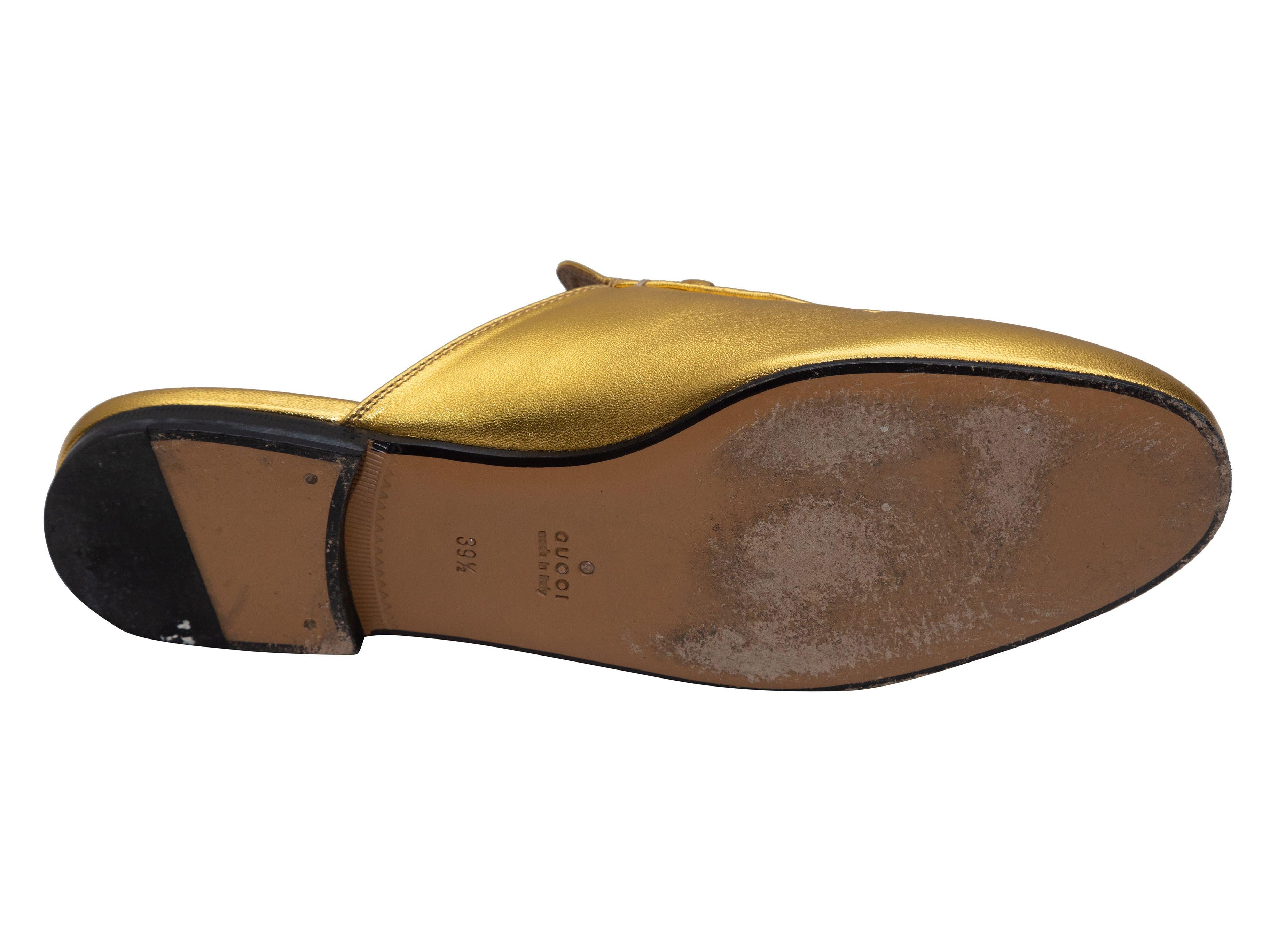 Product Details: Gold metallic leather Princetown loafer mules by Gucci. Gold-tone Horsebit accents at tops. 0.5