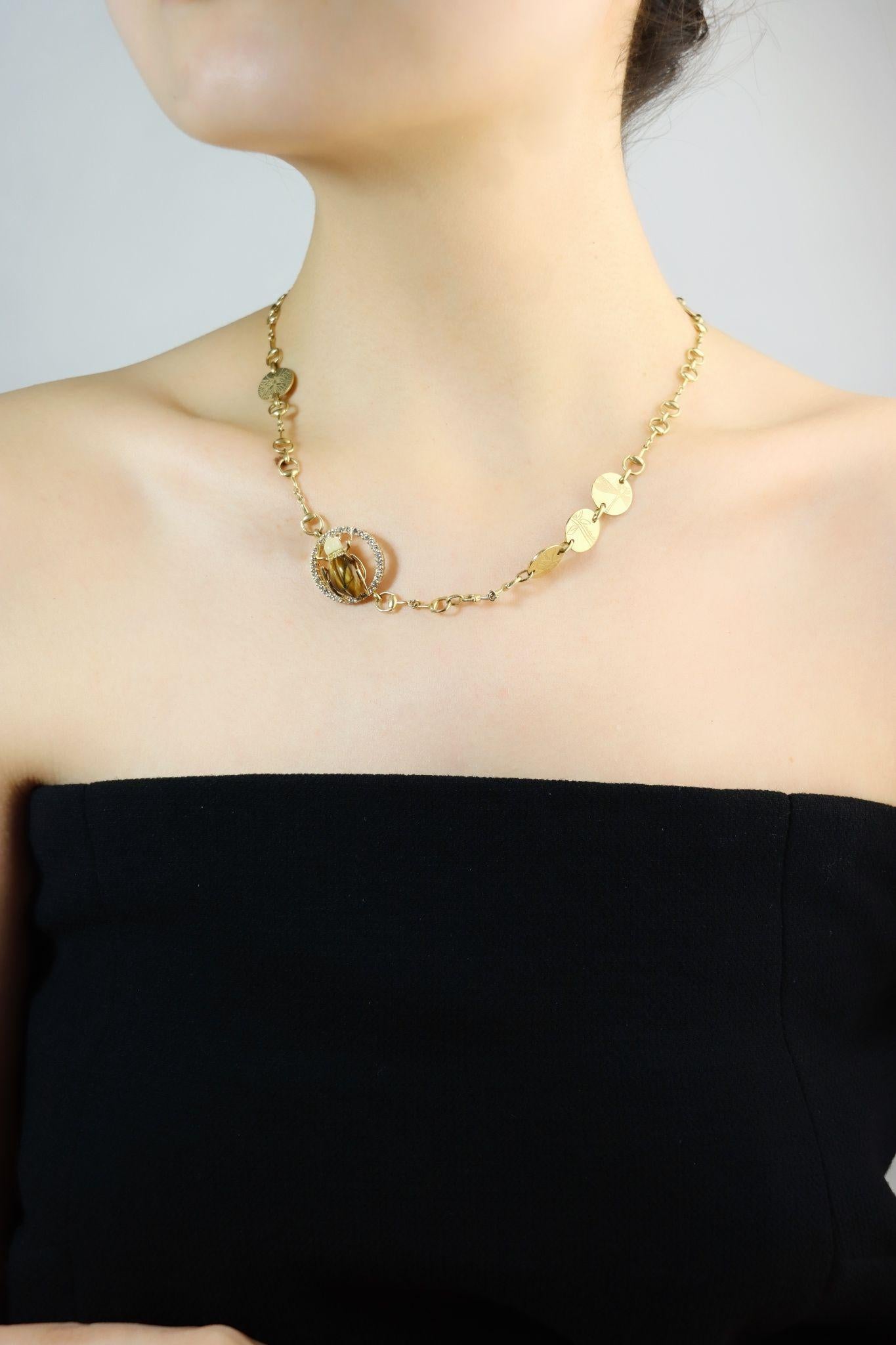 GUCCI 18K Gold Tiger Eye Insect Necklace

Marked:
GUCCI
MADE IN ITALY
STAMPED: 750 
Hall Marks - Number

Approximate Dimensions:
46.5 cm (Length) 
0.5 - 2.2 cm (Width)
28.0 grams in weight.