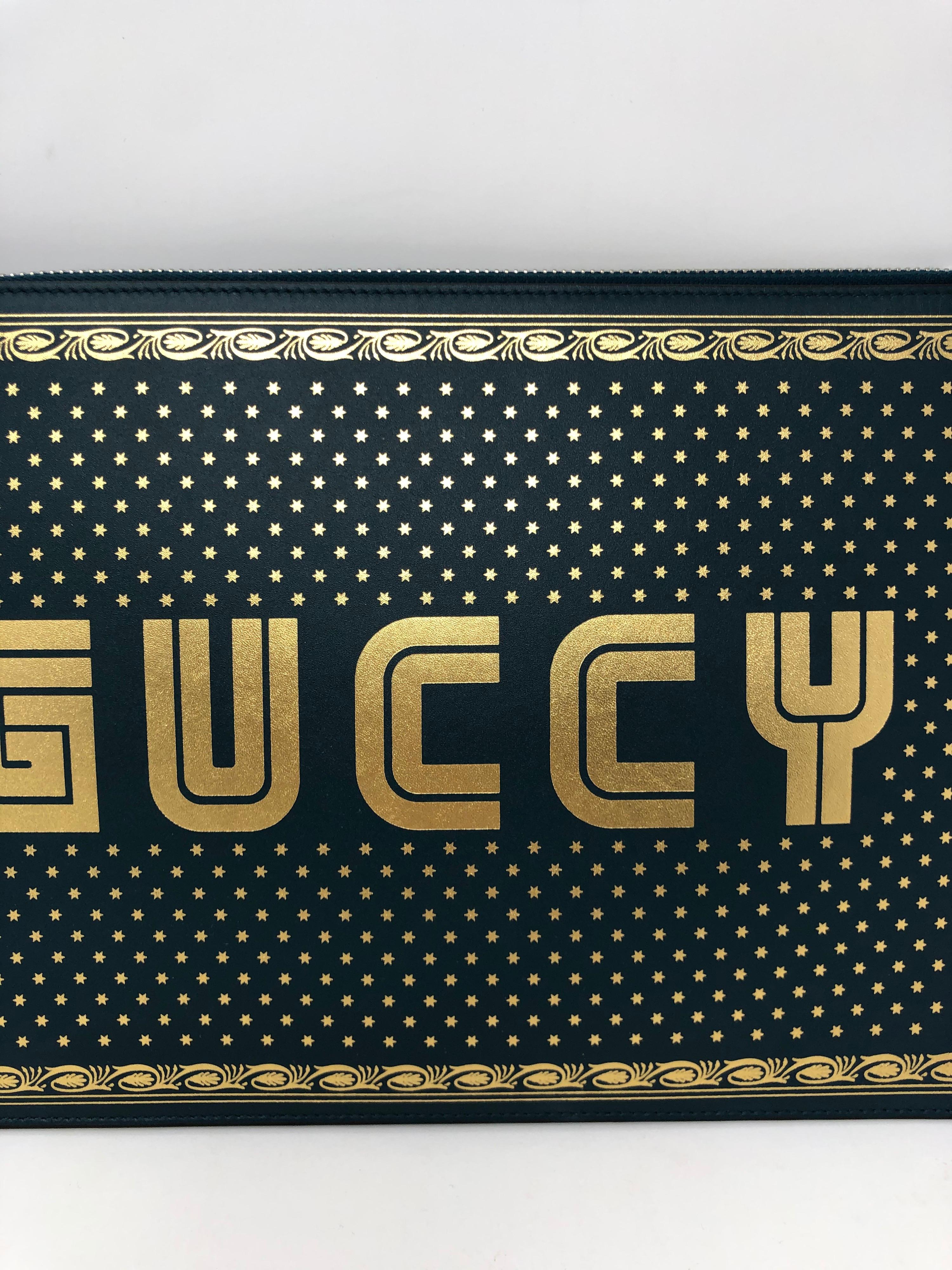 Gucci Green Clutch. Limited edition written out Guccy by Gucci. Gold embossed over green leather clutch. Excellent like new condition. Guaranteed authentic. 