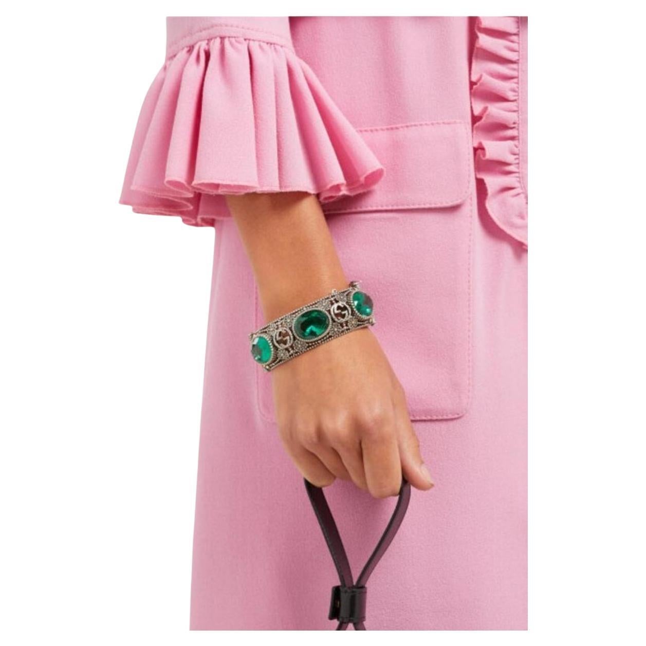 Follow us @runwaycatalog
Bracelet is crafted in Italy with the namesake motif interspersed with flowers - an archival tradition of the house - punctuated with faceted green crystals, and secures with a tiger - head bayonet fastening, for a sense of
