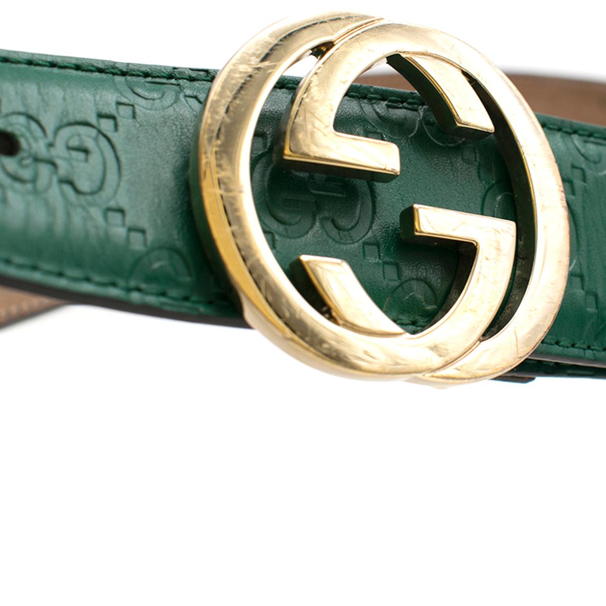 Gucci Gold and Green Embossed Leather Belt 

- Green Leather Belt 
- Embossed with Gucci logo throughout 
- Gold toned signature logo buckle 
- 5 holes 
- Brown lining 
- This item comes with a dust bag. 

Please note, these items are pre-owned and