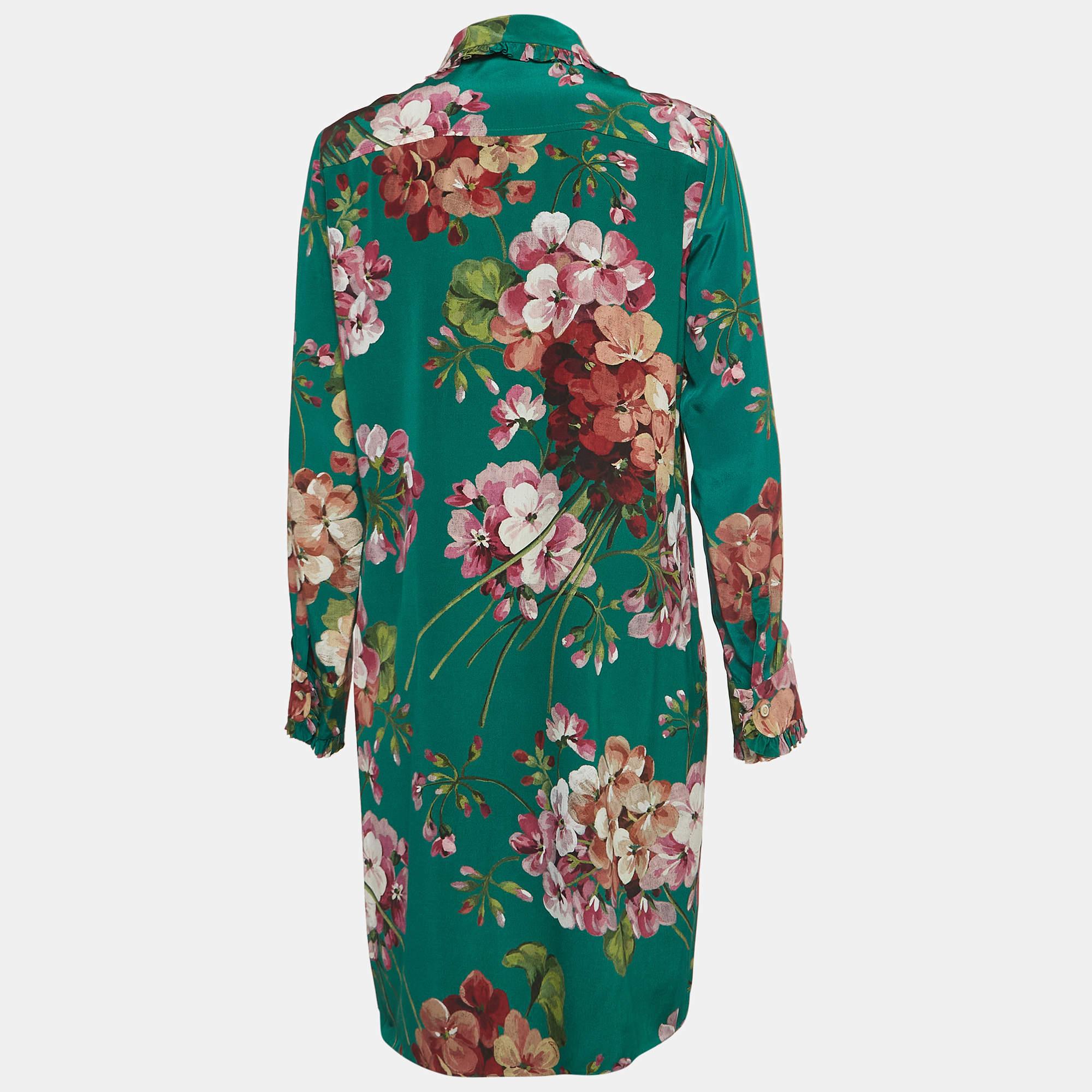 Draped in luxurious silk, the Gucci dress exudes effortless charm. Delicate floral motifs dance across the fabric, adding a touch of whimsy to its emerald hue. With its relaxed silhouette and refined collar, it effortlessly blends style and comfort