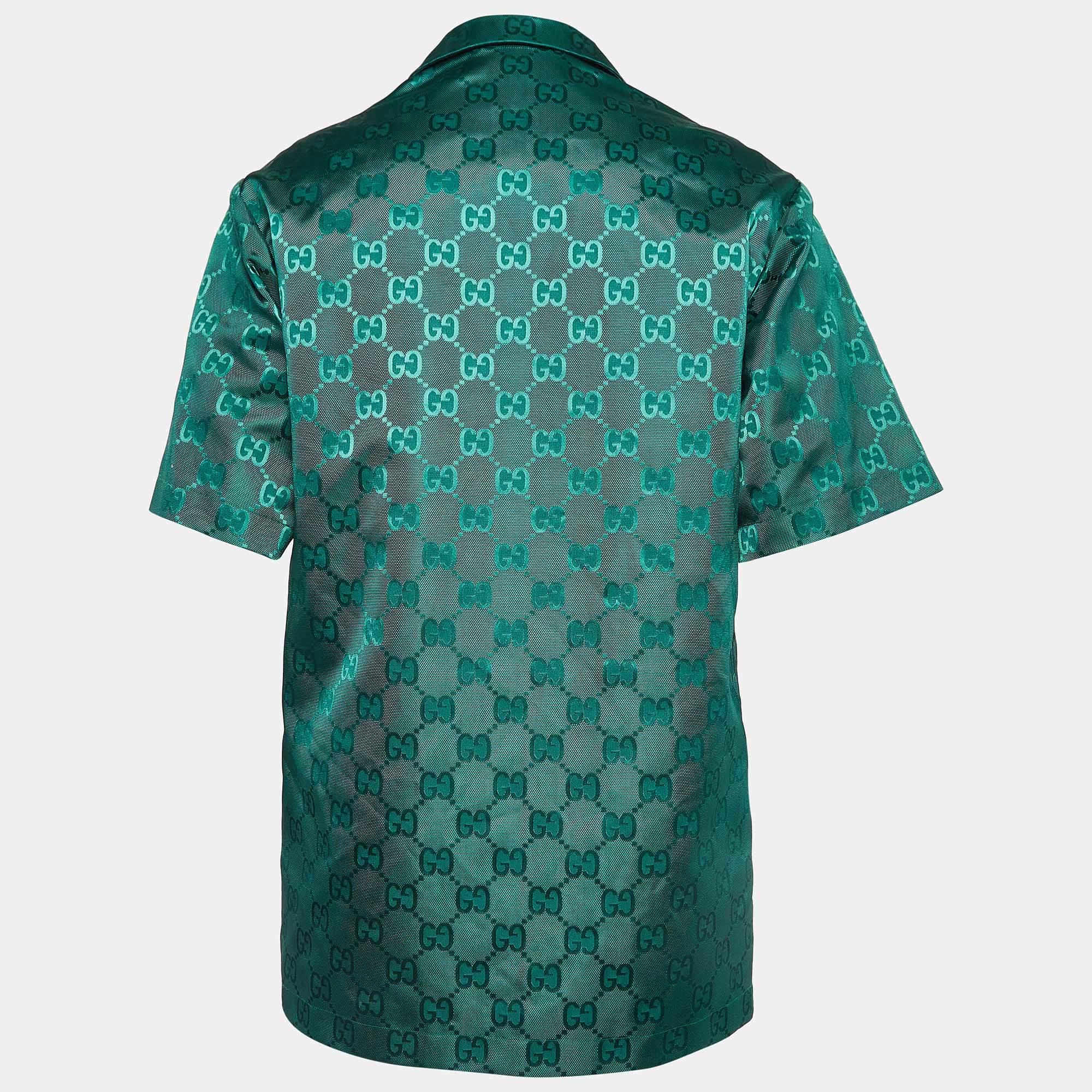 Das Gucci Bowlinghemd ist der Inbegriff lässiger Eleganz. Sie ist aus hochwertigen Materialien gefertigt und in einem grünen Farbton mit dezenten Prints gehalten. Die entspannte Silhouette des Bowlinghemds wird durch eine geknöpfte Vorderseite,