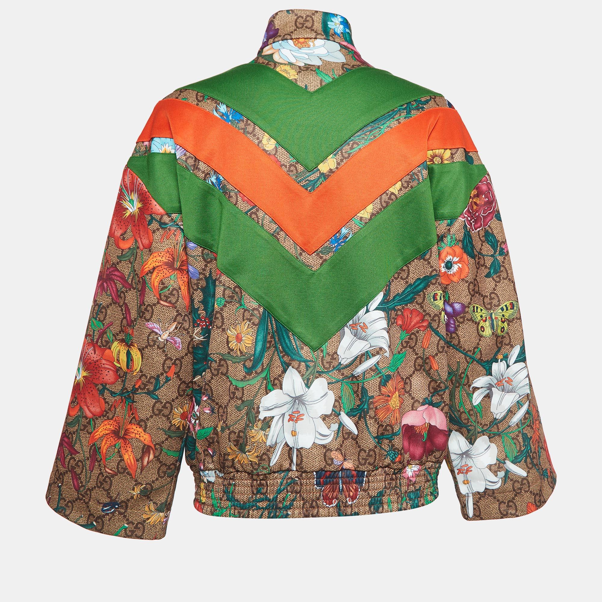 The Gucci jacket exudes vibrant charm with its iconic GG Supreme pattern adorned with lively florals. Crafted with meticulous attention to detail, it offers both style and comfort, perfect for adding a dash of luxury to your casual ensemble.

