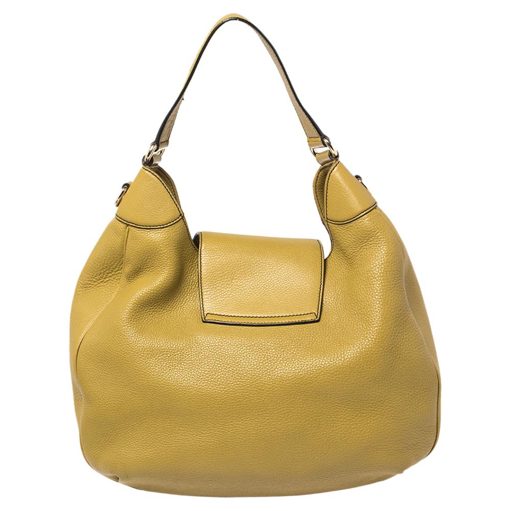 Crafted in leather, this Gucci Emily hobo is finished with a flap closure secured with a tassel detailed, gold-tone lock. It comes with a flat handle. It is ultra-spacious and can be a great alternative to your weekend travel bag.

