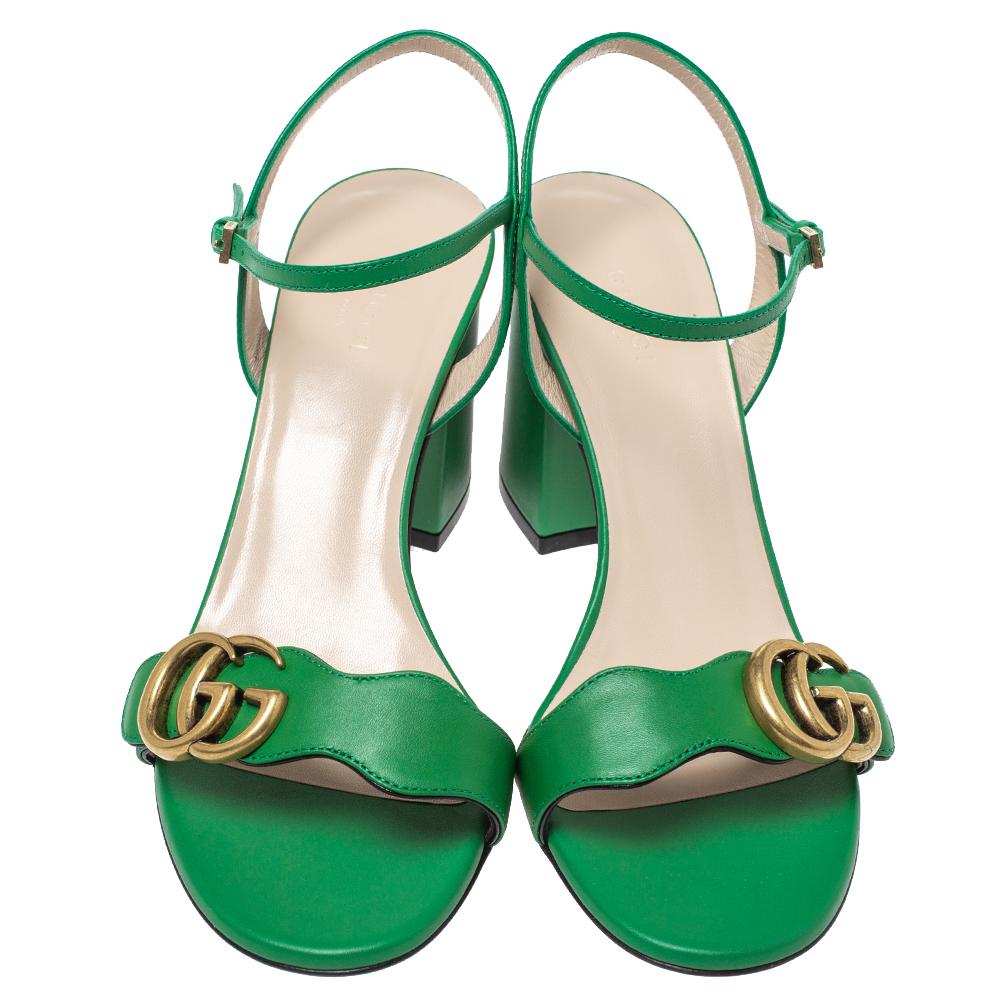How gorgeous are these GG Marmont sandals from Gucci! Crafted in Italy, they are made from leather and adorned in a green shade. They are styled with open toes, GG logo on the vamp straps, buckled ankle straps, low block heels, and gold-tone