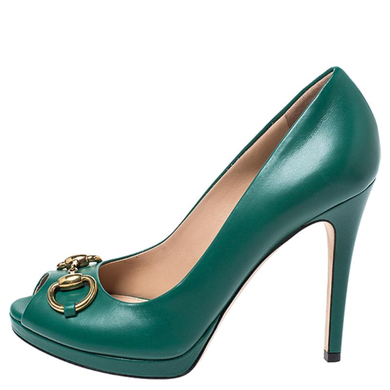 These classic Gucci peep-toe pumps make for an ideal formal and informal adornment. Crafted in green leather, they feature the brand's signature Horsebit in gold-tone on the vamps and come with 10 cm heels and leather insoles and soles. They will